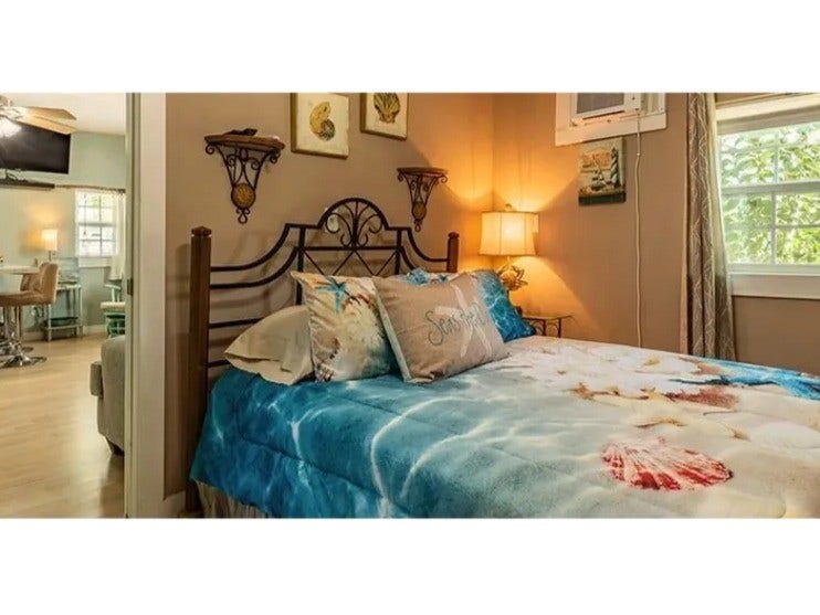 3709 Bayshore Drive, #1-12, Bacliff, TX 77518 Charming bedroom in the Doc Holiday with cozy decor, natural light, and a seamless flow into the living area for a warm and inviting atmosphere.