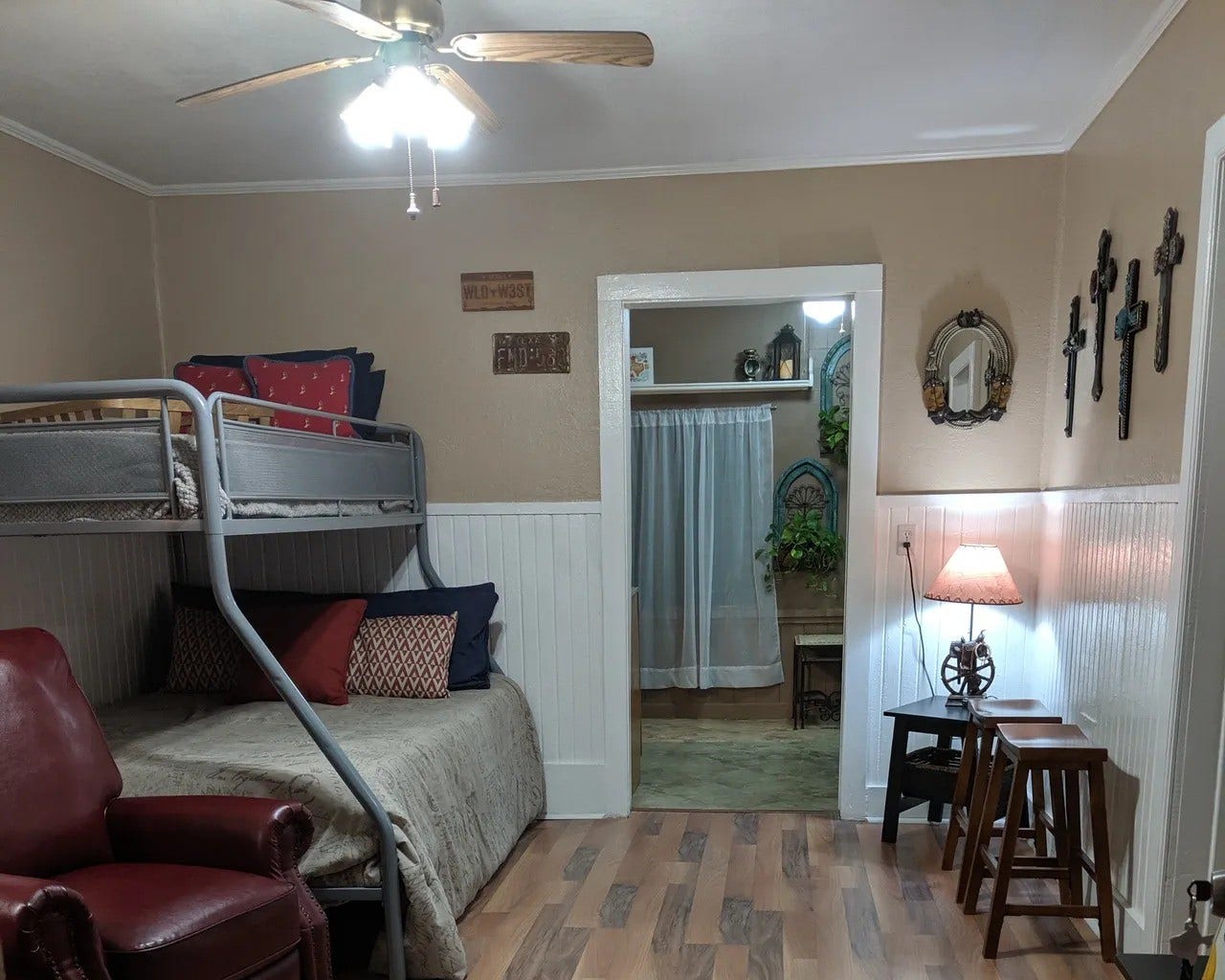 3709 Bayshore Drive, #1-12, Bacliff, TX 77518 Charming and cozy room in the Tejas featuring a stylish bunk bed, warm wood flooring, and tasteful decor. Ideal for comfortable living with inviting lighting and a welcoming ambiance. Perfect for creating lasting memories.