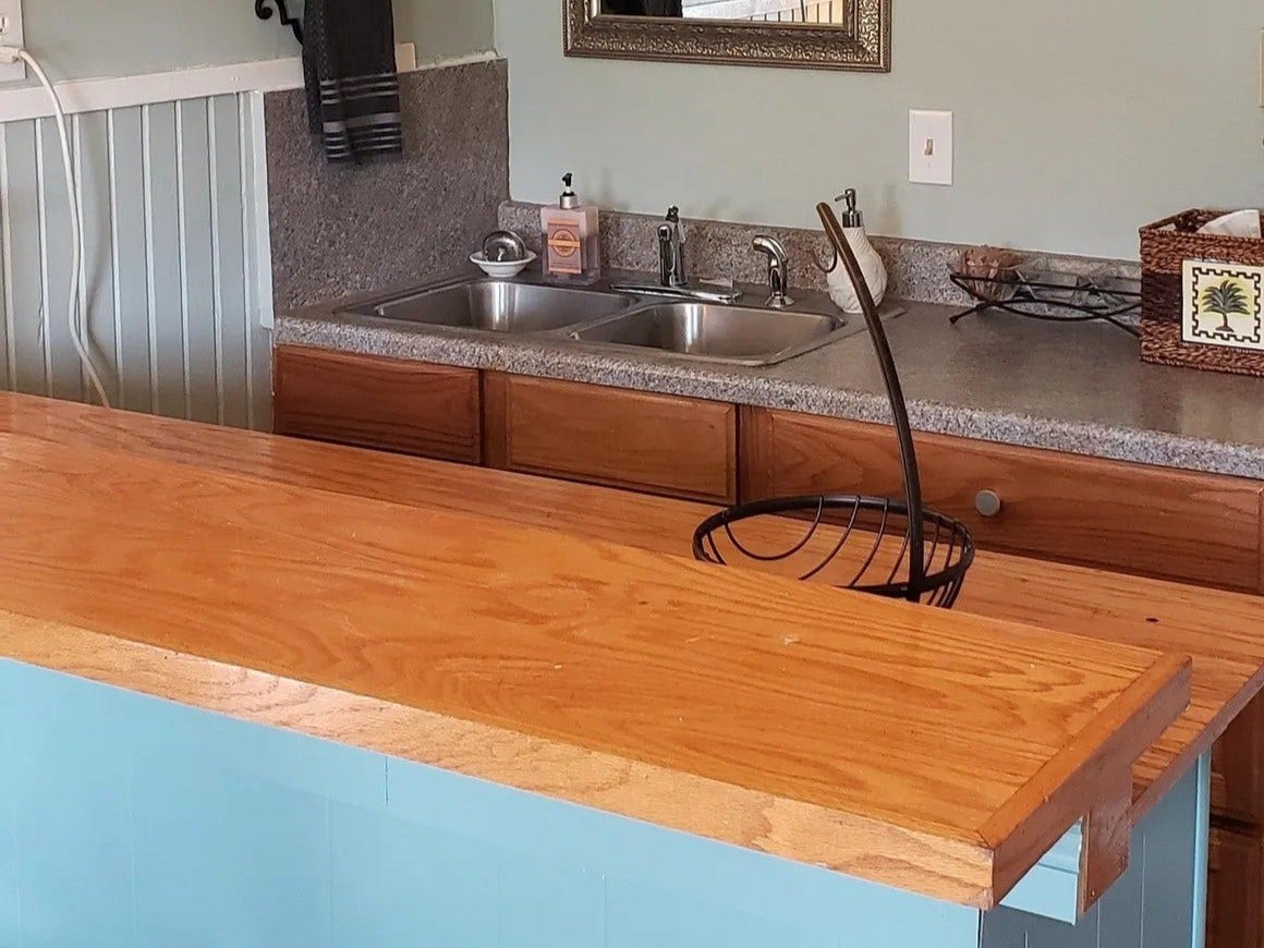 3709 Bayshore Drive, #1-12, Bacliff, TX 77518 Charming and functional kitchen in the Laurel Anne featuring a sleek double sink, cozy wooden countertops, and stylish cabinetry, perfect for culinary enthusiasts.
