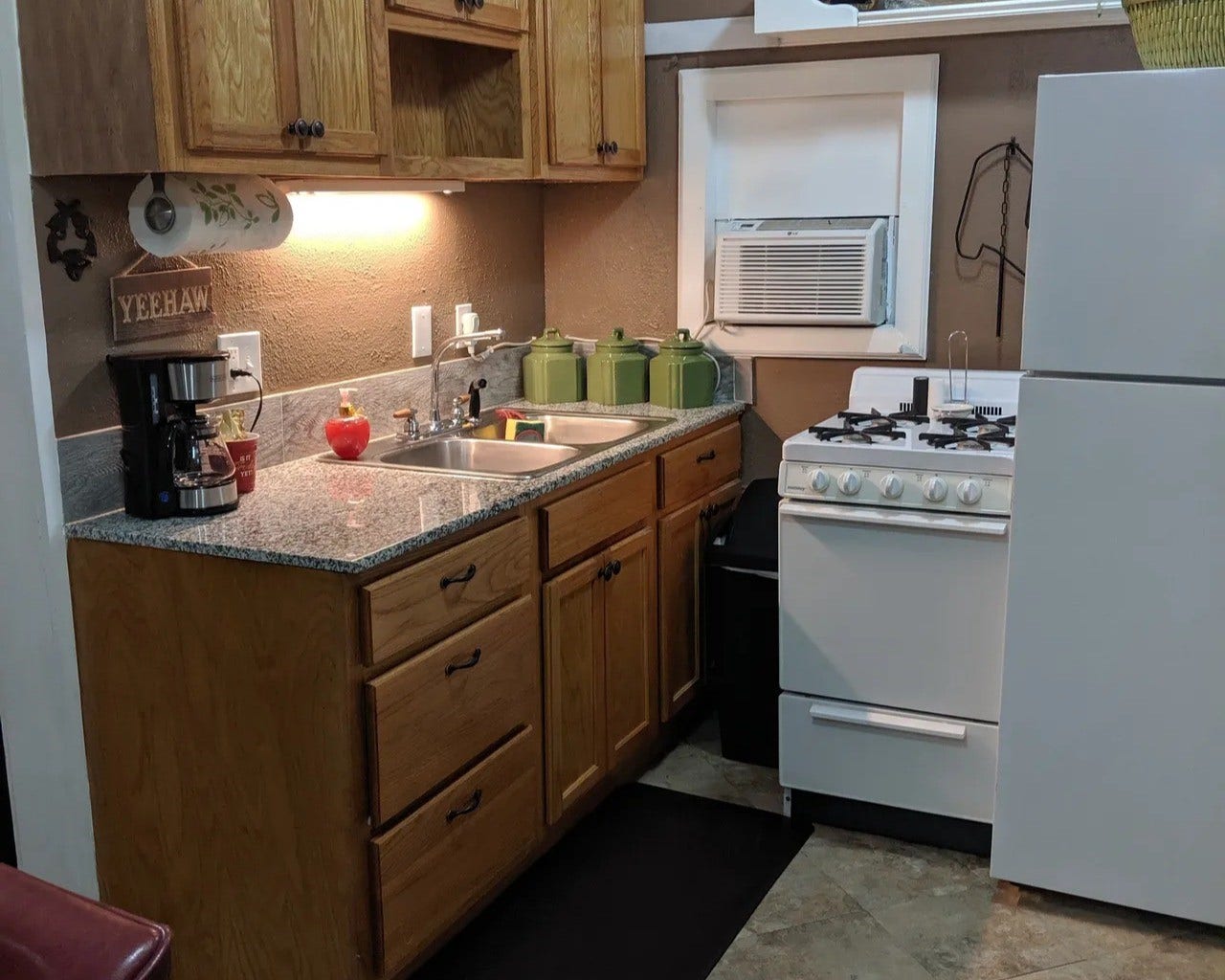 3709 Bayshore Drive, #1-12, Bacliff, TX 77518 Cozy kitchen in the Tejas with charming wooden cabinets, sleek granite countertops, and modern appliances, perfect for culinary enthusiasts.