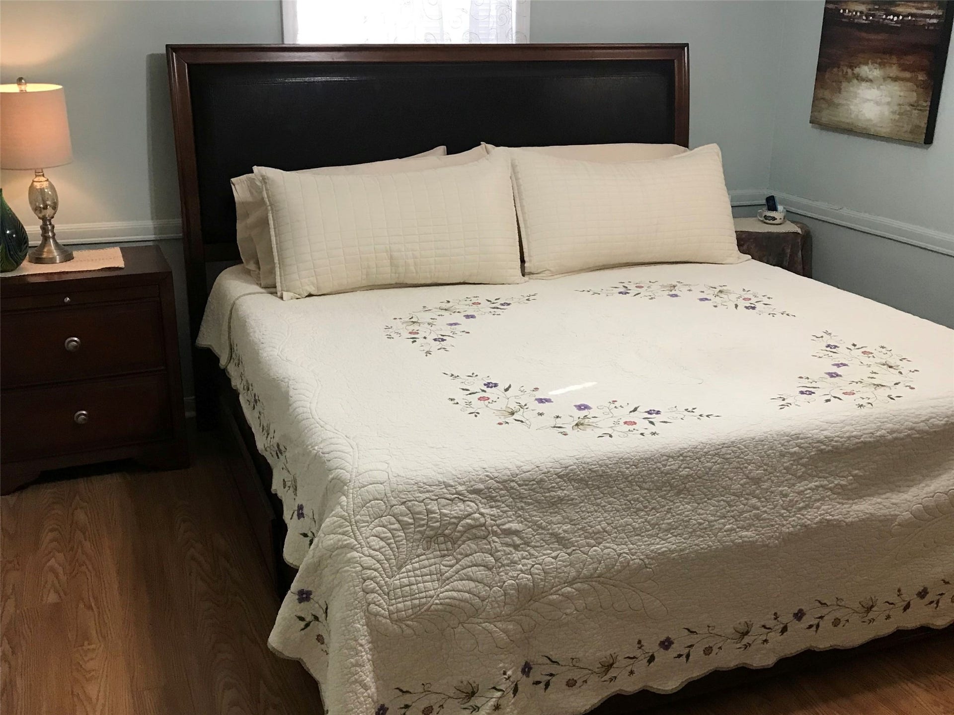 3709 Bayshore Drive, #1-12, Bacliff, TX 77518 Cozy bedroom in Annie's Song featuring a plush bed with an elegant embroidered coverlet, accompanied by warm lighting and tasteful decor. Perfect for relaxation and comfort.