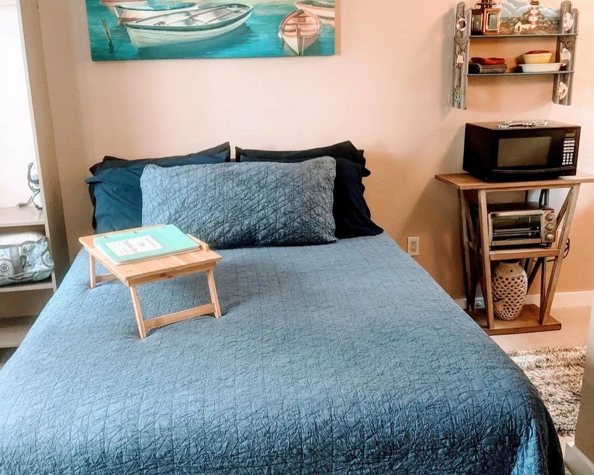 3709 Bayshore Drive, #1-12, Bacliff, TX 77518 Charming bedroom in the Tackle Box with cozy decor, featuring nautical accents and convenient amenities like a microwave and toaster oven. Perfect for relaxation and functionality.