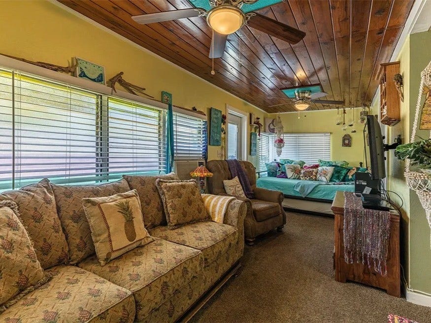 3709 Bayshore Drive, #1-12, Bacliff, TX 77518 Charming living room in the Saltwater Gypsy with coastal decor, cozy seating, and a relaxing ambiance. Perfect for unwinding by the sea.