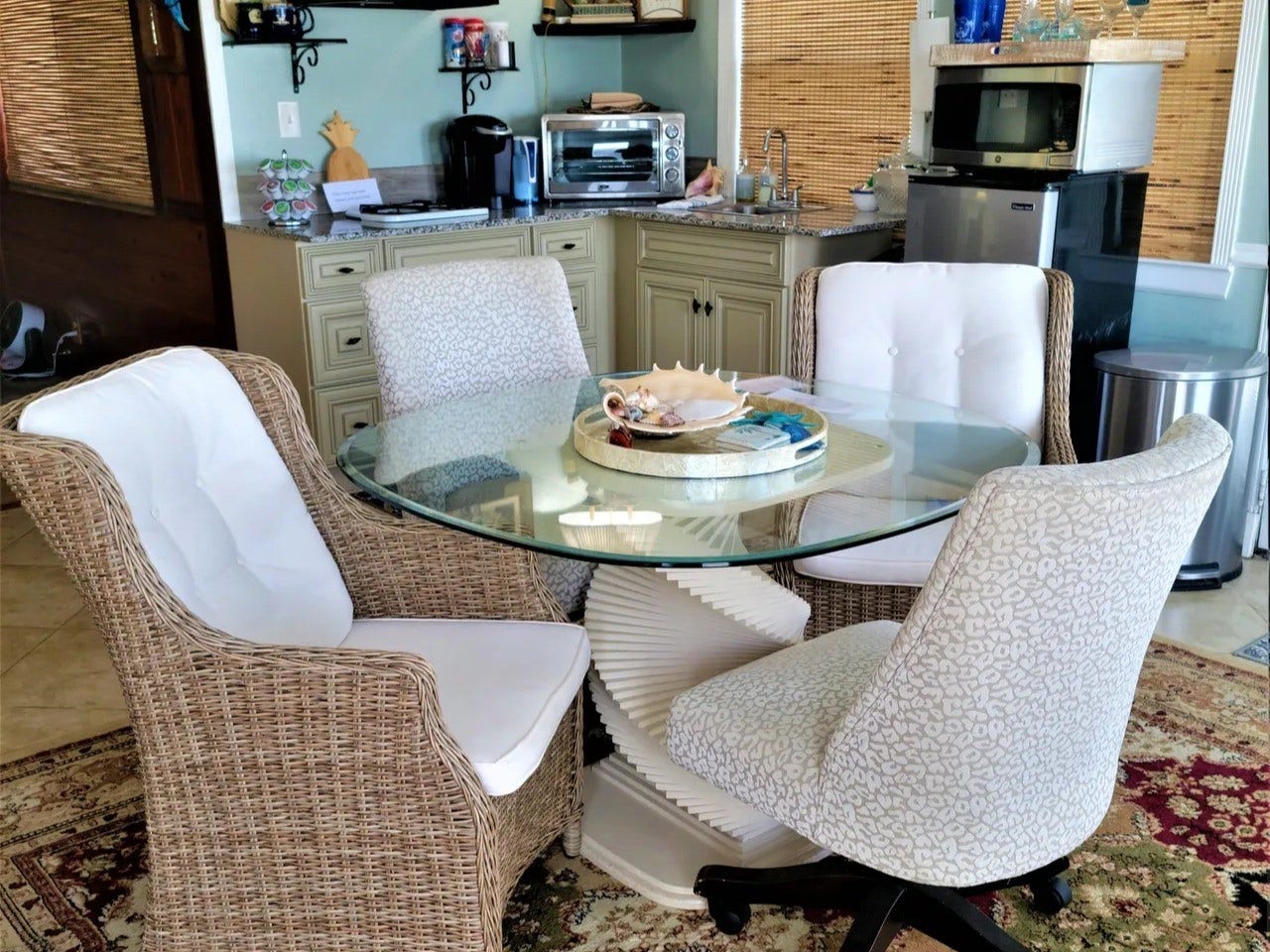 3709 Bayshore Drive, #1-12, Bacliff, TX 77518 Cozy and inviting, this Bay Room features elegant wicker seating and a stylish glass-topped table, perfect for intimate gatherings or relaxing moments.