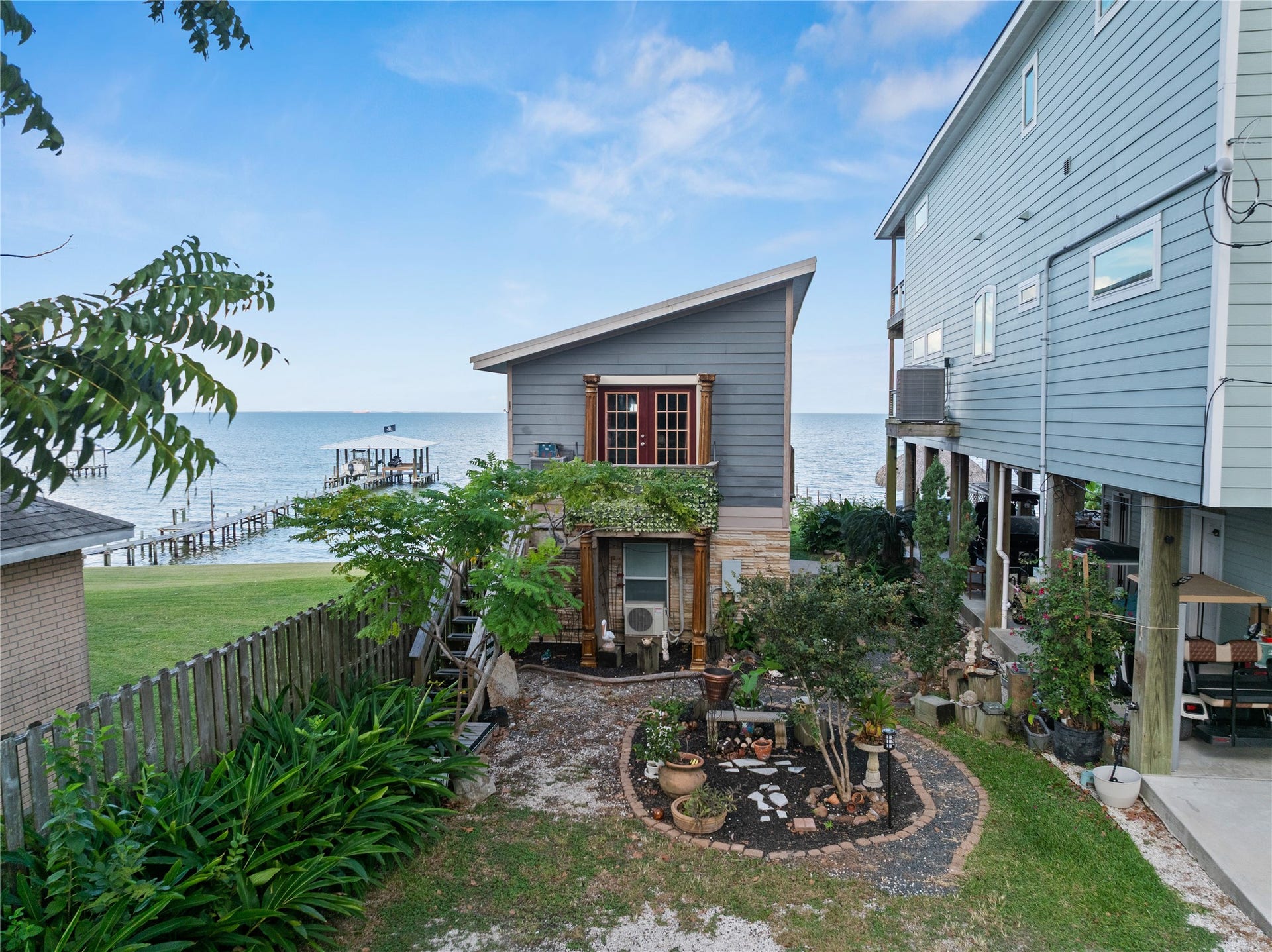 3709 Bayshore Drive, #1-12, Bacliff, TX 77518 This photo of The LaView Suite offers stunning views of the bay with direct access to a private pier. The cozy garden adds a touch of tranquility.