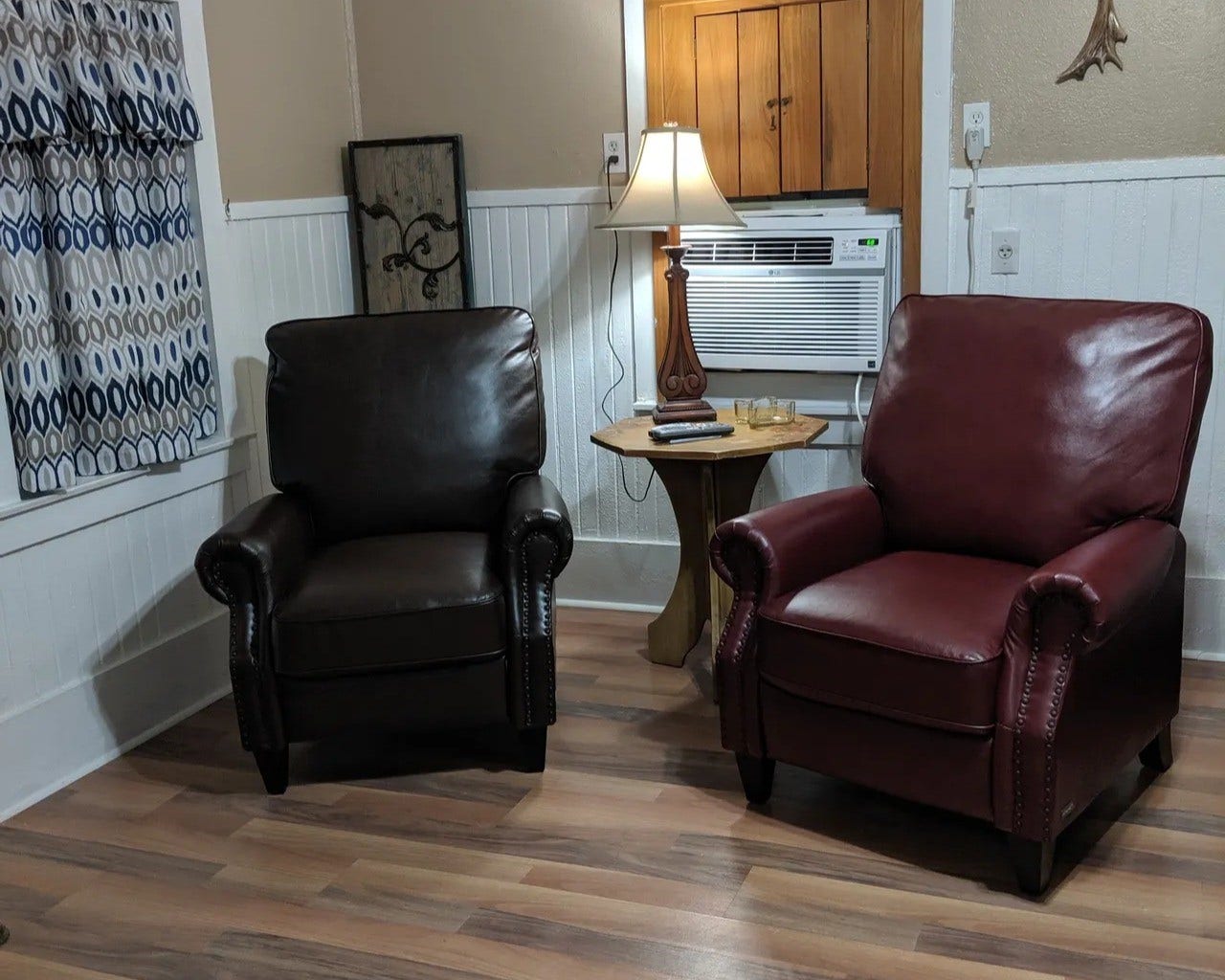 3709 Bayshore Drive, #1-12, Bacliff, TX 77518 Cozy and inviting, this living space in the Tejas features two plush armchairs, warm wood accents, and ample natural light. Perfect for relaxation and comfort.