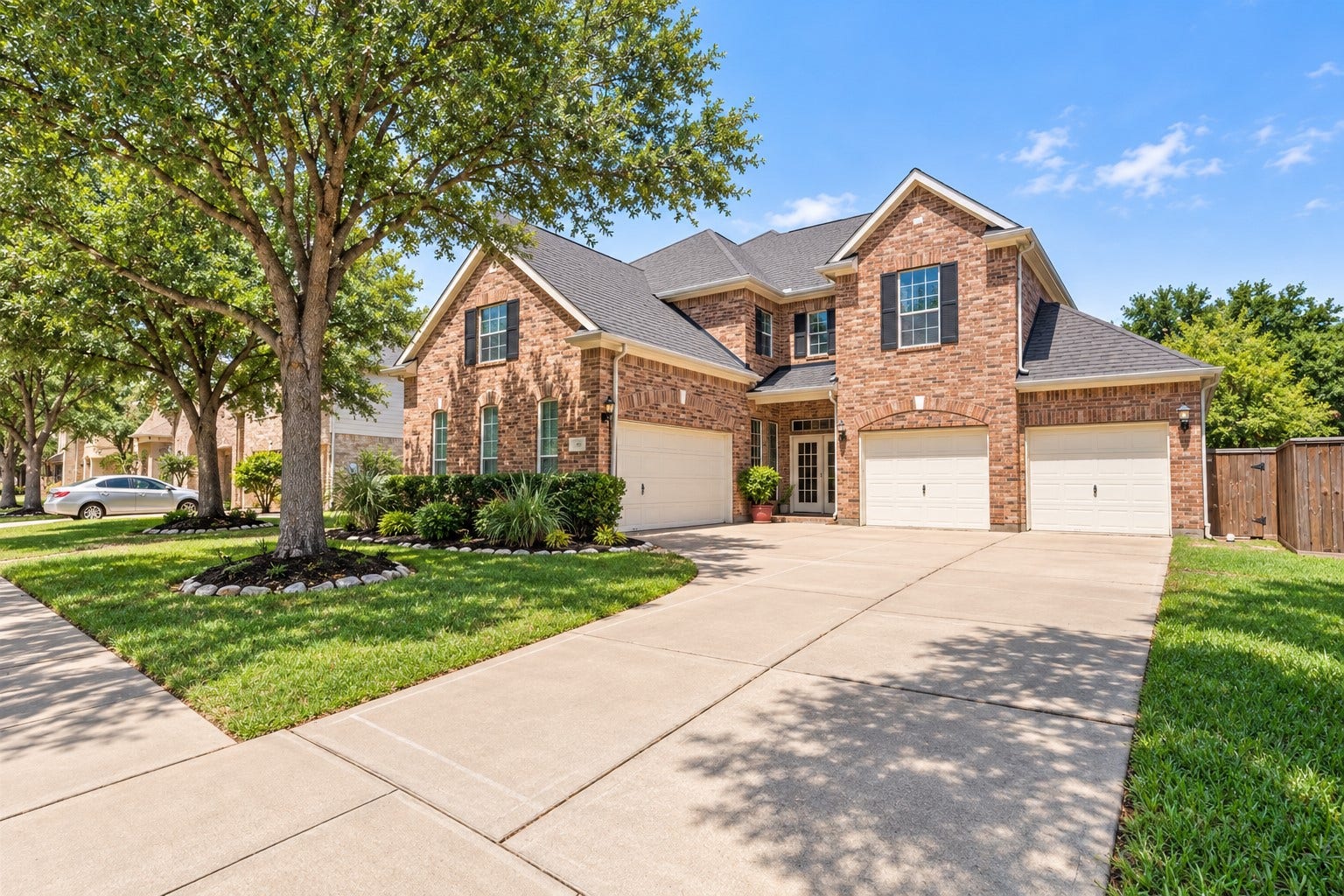 26418 Cottage Cypress Lane, Cypress, TX 77433 Spacious 4-car garage with convenient secondary entrance through double French doors leading into the hall near the kitchen, while the homes main front entry provides a welcoming entrance for guests.