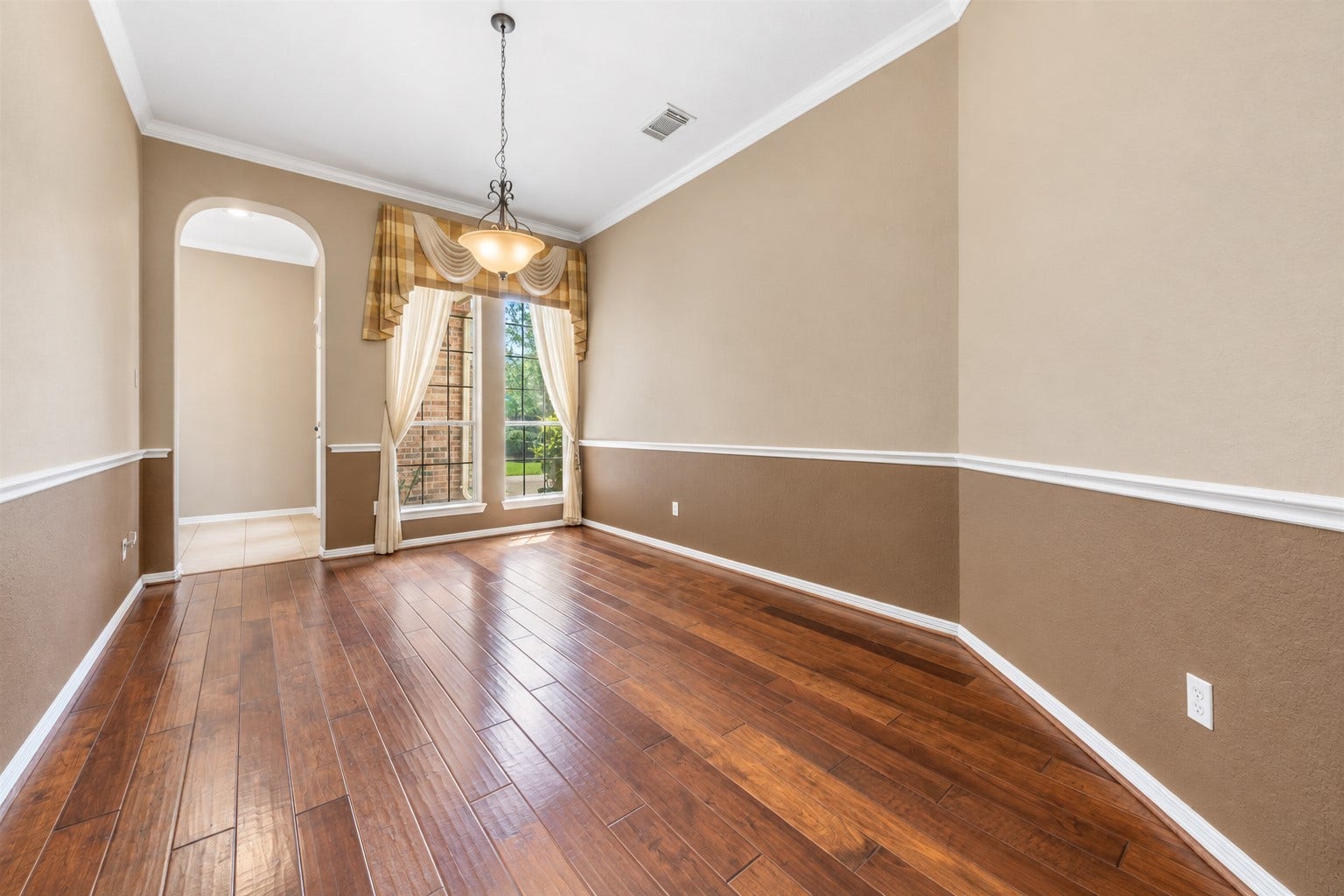 26418 Cottage Cypress Lane, Cypress, TX 77433 Upon entering the front door you will see the formal dining room on your left. Spacious room with 2 ways to exit. The room is centered by a chaming chandelier and large double window that invites in natural light.