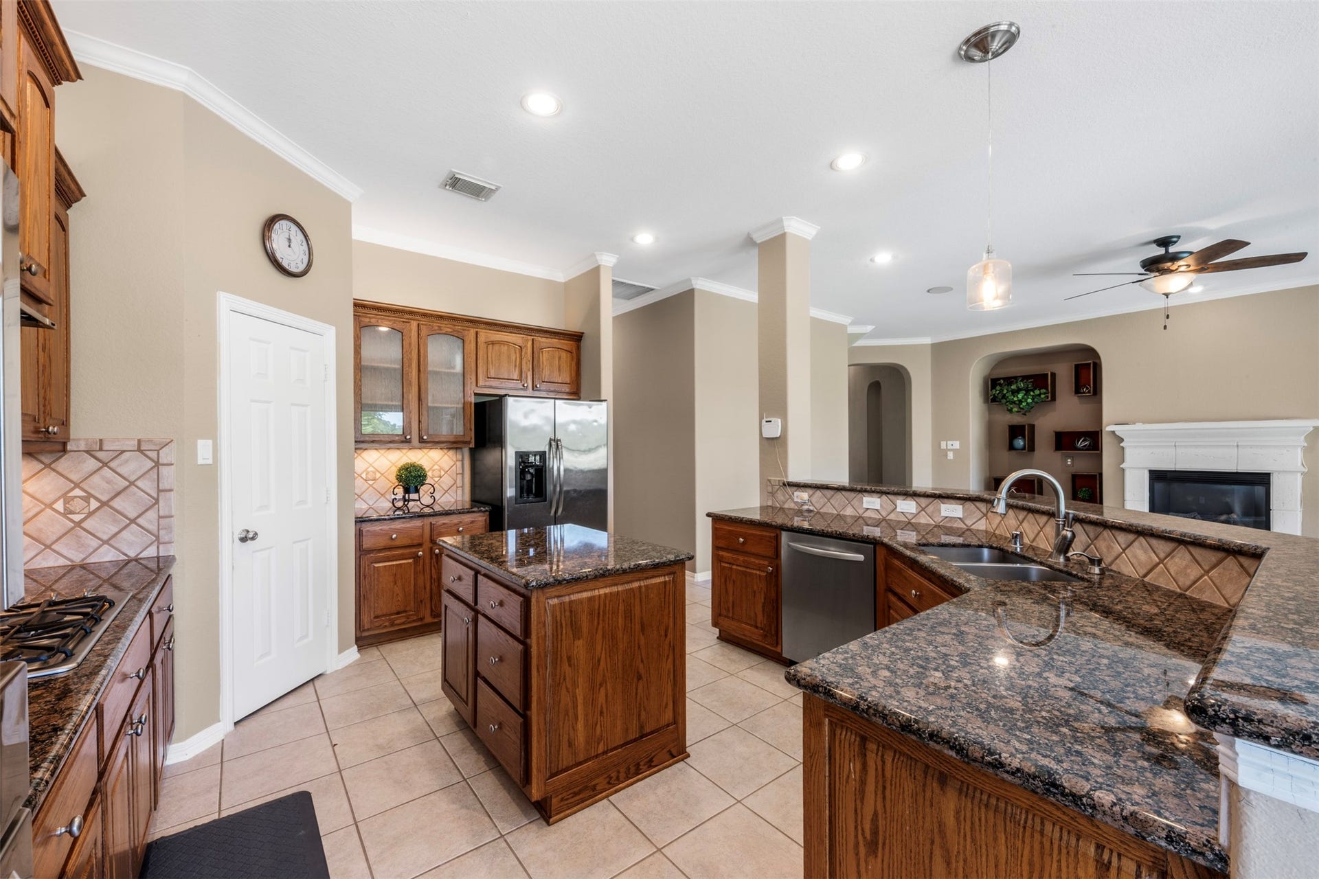 26418 Cottage Cypress Lane, Cypress, TX 77433 An expansive, open-concept kitchen featuring countertops and a functional island, seamlessly flowing into the living area for effortless entertaining and everyday comfort.