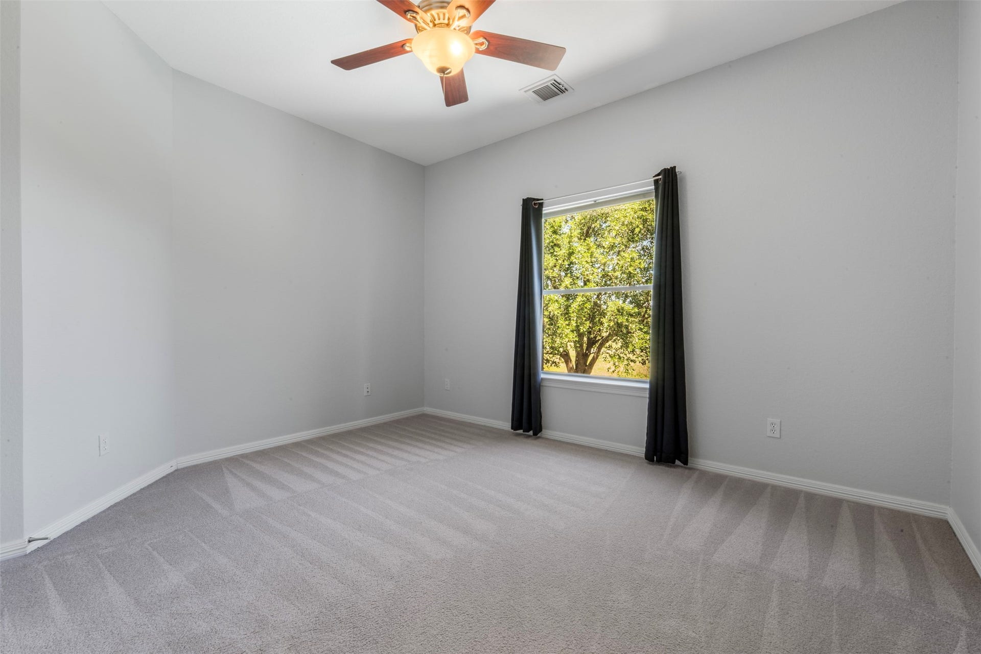 26418 Cottage Cypress Lane, Cypress, TX 77433 This room is on the 2nd floor facing the back of the home over looking the golf course and pool. This bright secondary bedroom features a ceiling fan for added comfort, with a large window that provides abundant natural light.