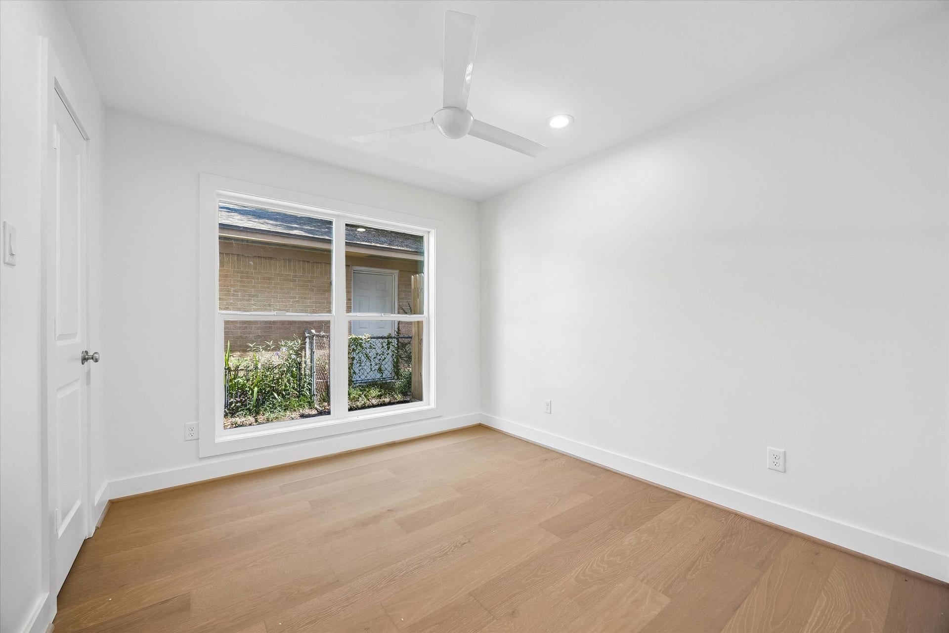 10659 Mayfield Road, Houston, TX 77043 This centrally located bedroom features a large window that brings in ample natural light, creating a bright and airy atmosphere. It's positioned on the right side of the property, providing a quiet and private space.