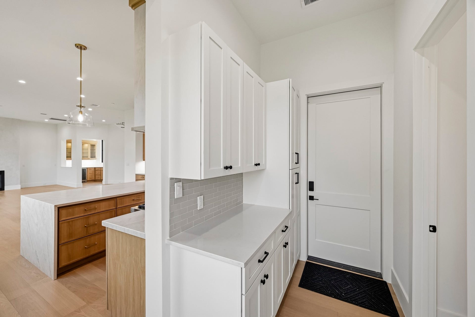 Just in from the garage are the mudroom, powder bath, and working pantry!