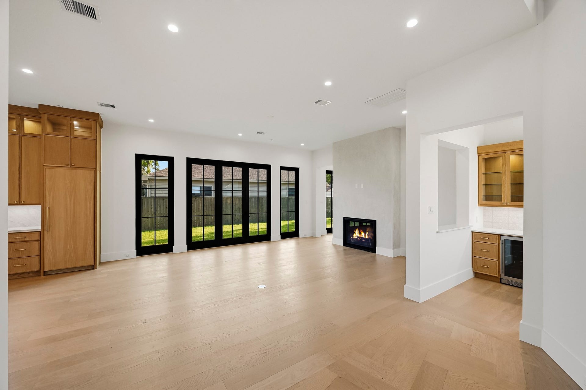 Past the elevator closet, the foyer opens to the family room and bar!
