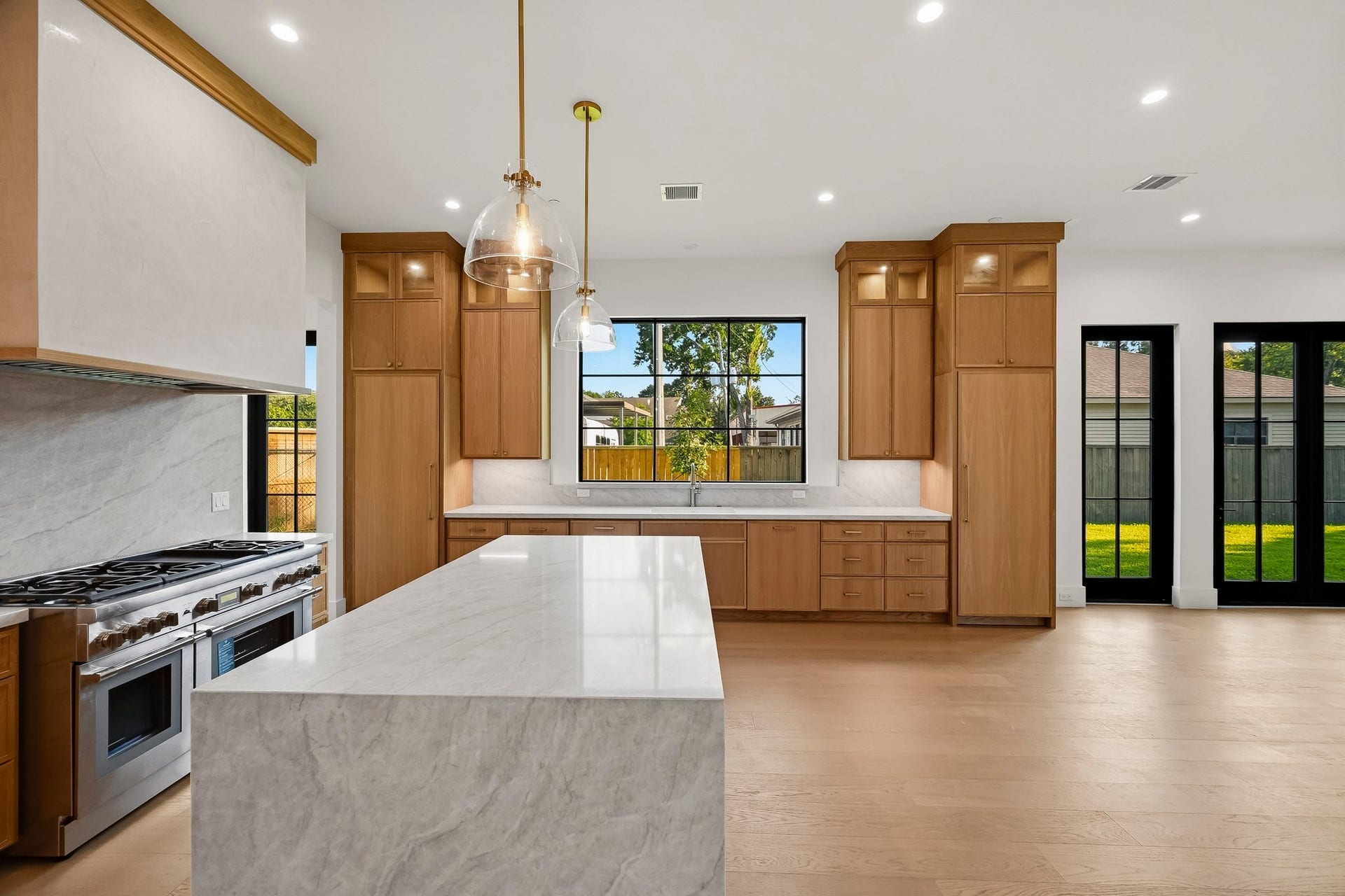 Luxurious touches in the waterfall island and venetian plaster vent hood!