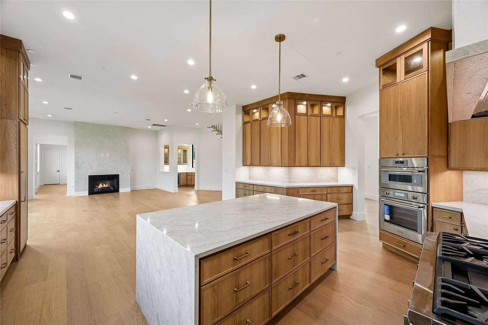 Incredible open concept kitchen with custom cabinetry and Taj Mahal quartz!