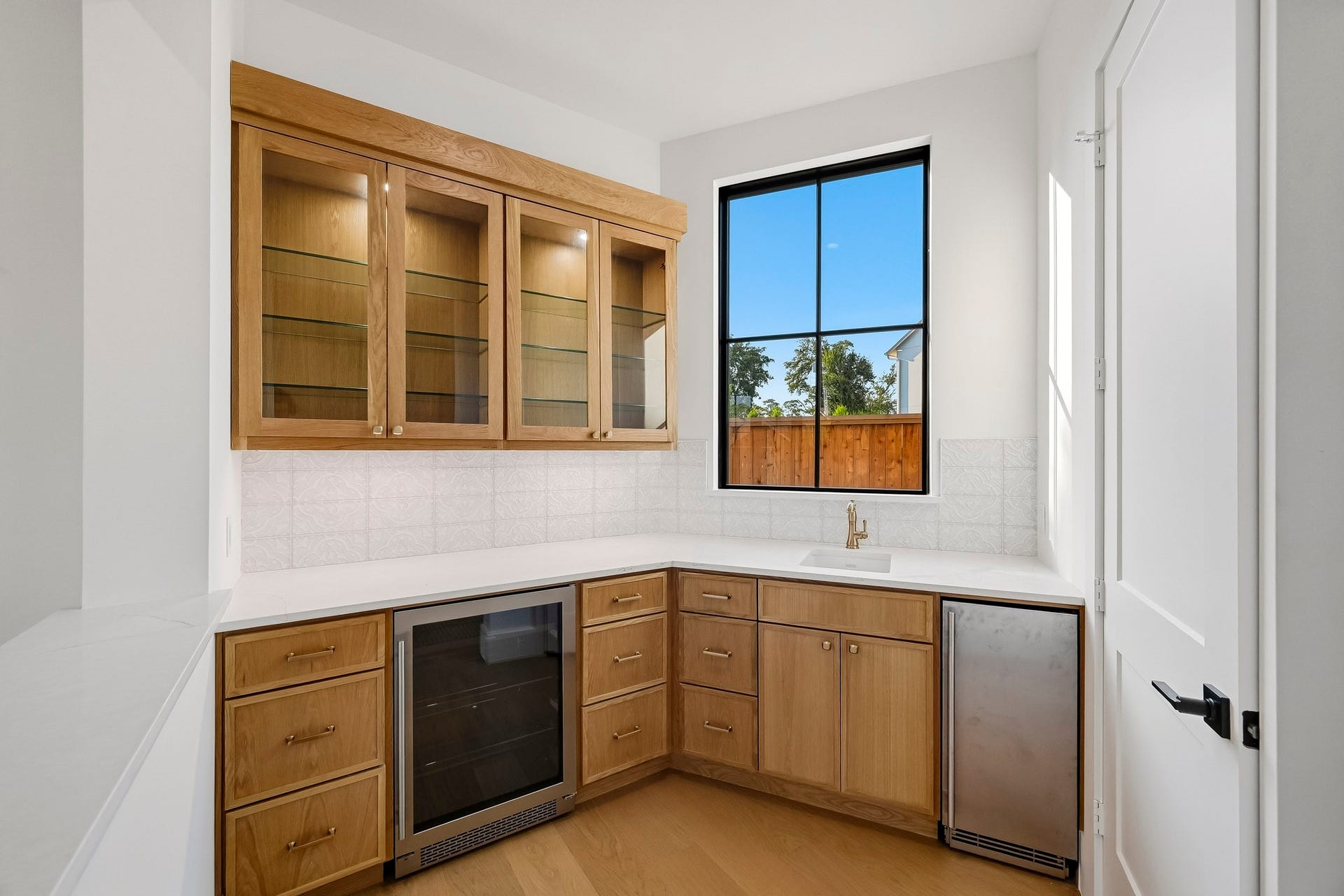 Your fully equipped bar has a sink, icemaker, wine fridge, and a massive under-stairs closet!