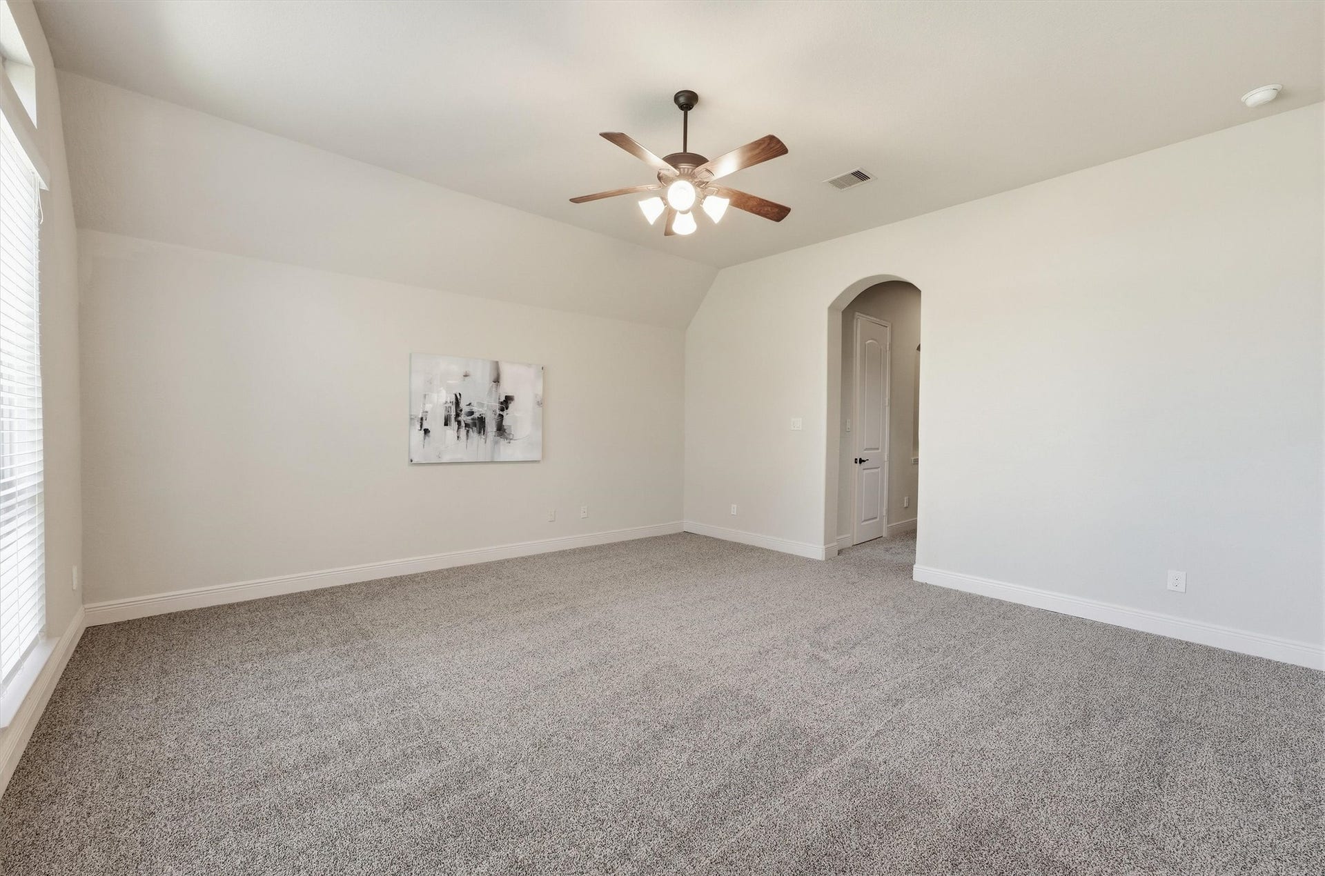 Private primary suite with multiple windows and plenty of natural light.