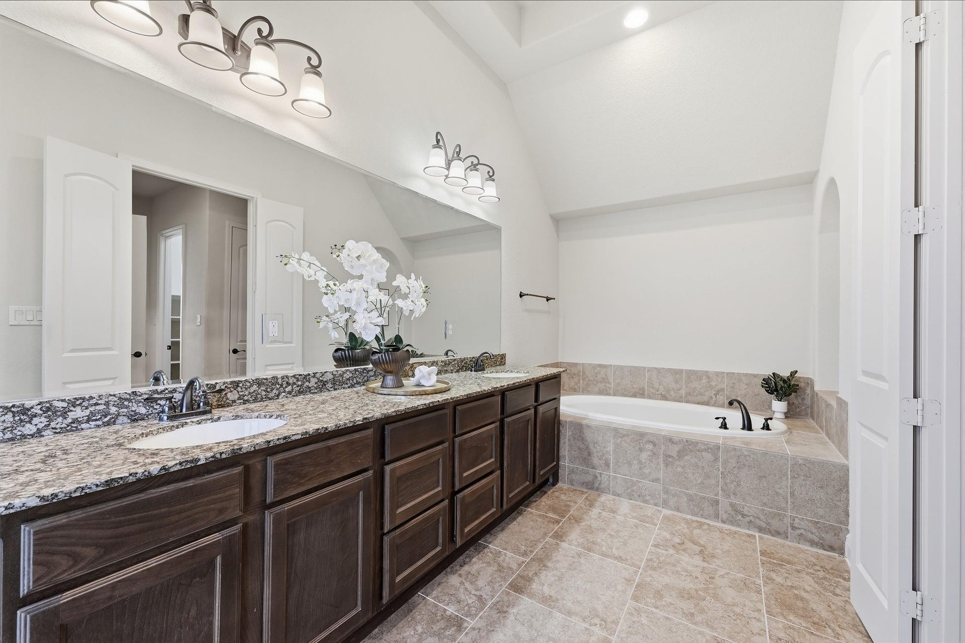 Primary bath features dual sinks, soaking tub, and separate walk-in shower.