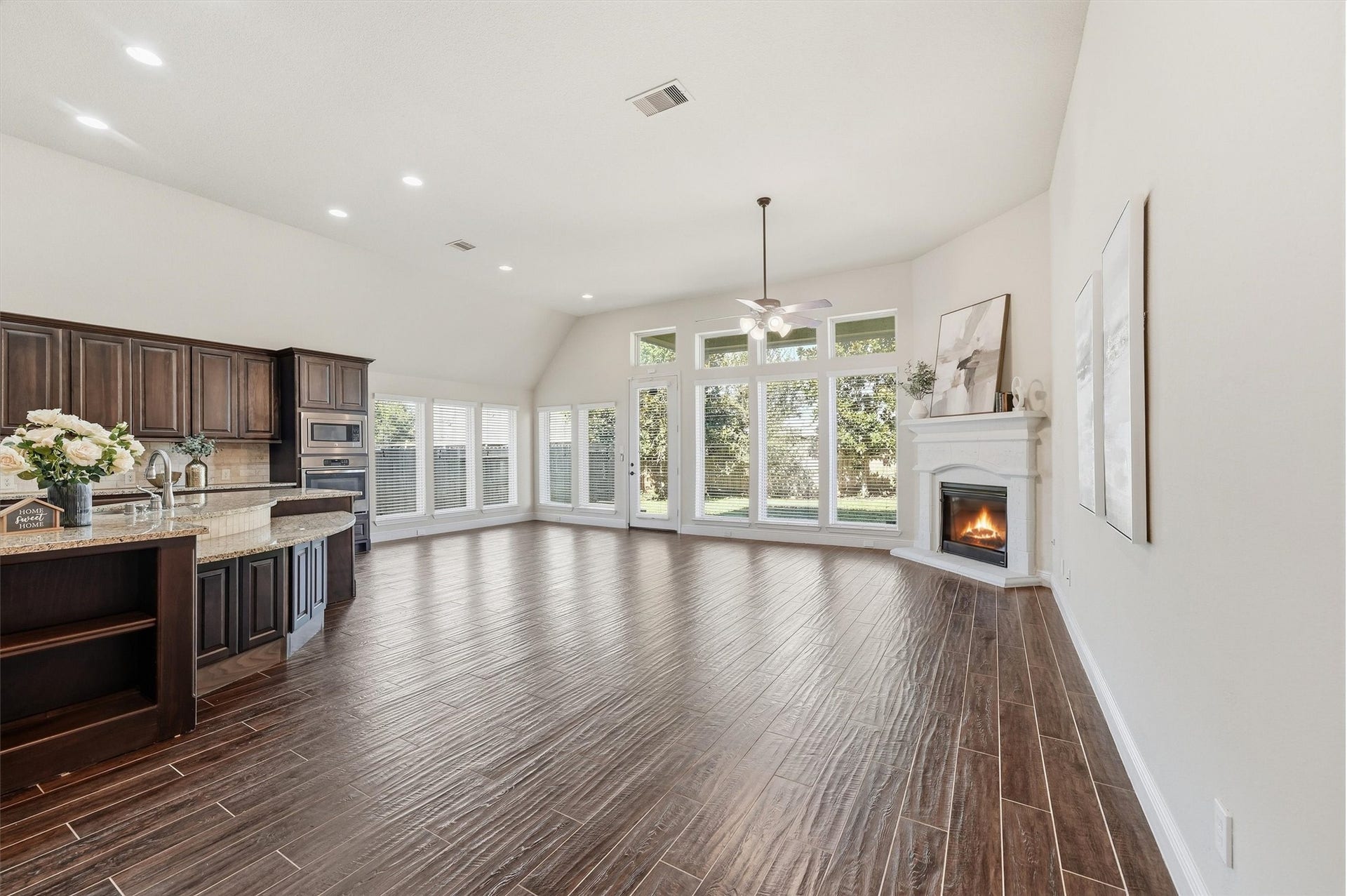 Large windows bring abundant natural light into the open living space.