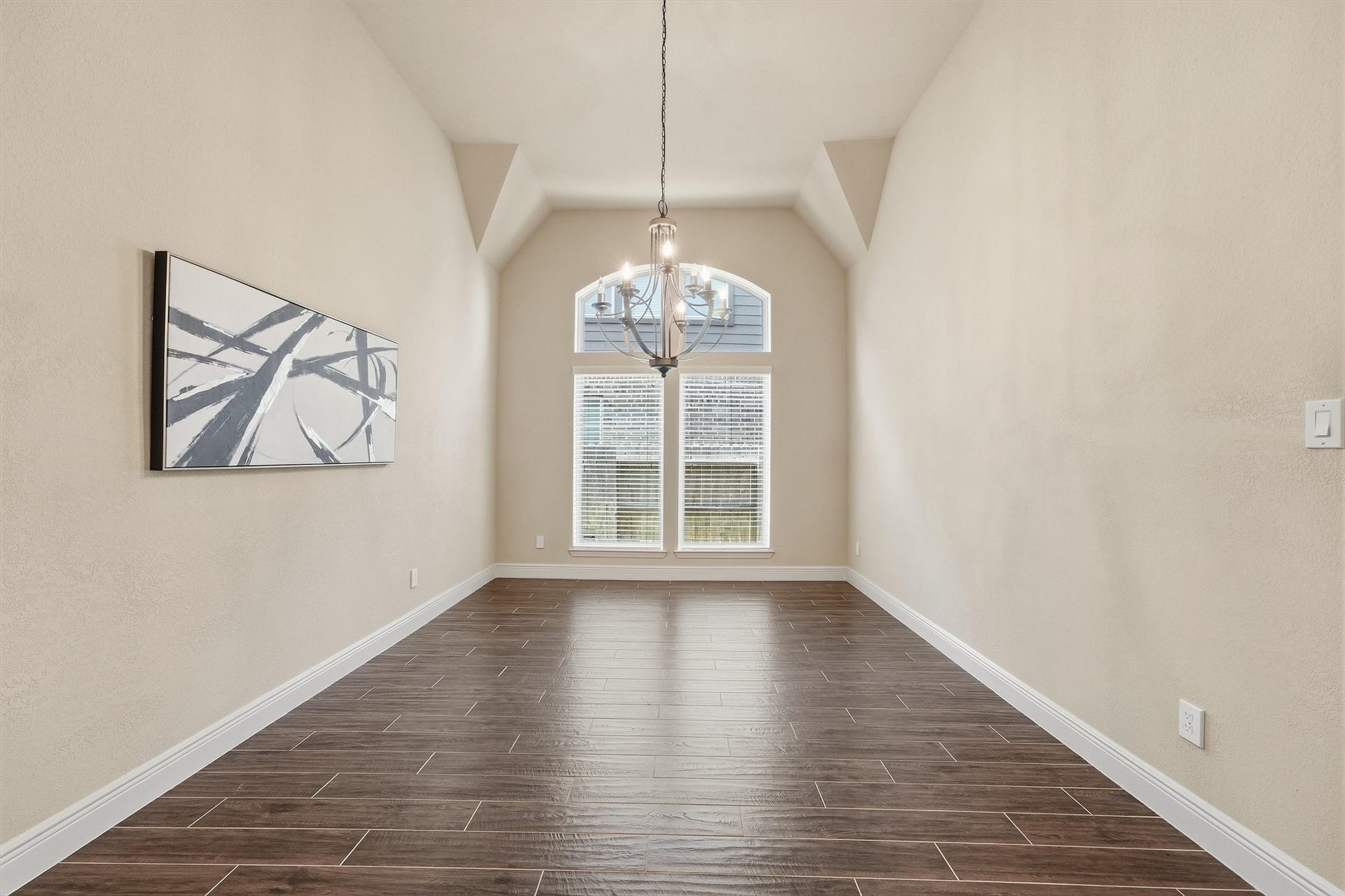 Formal dining room with 12-foot ceiling and hardwood flooring.
