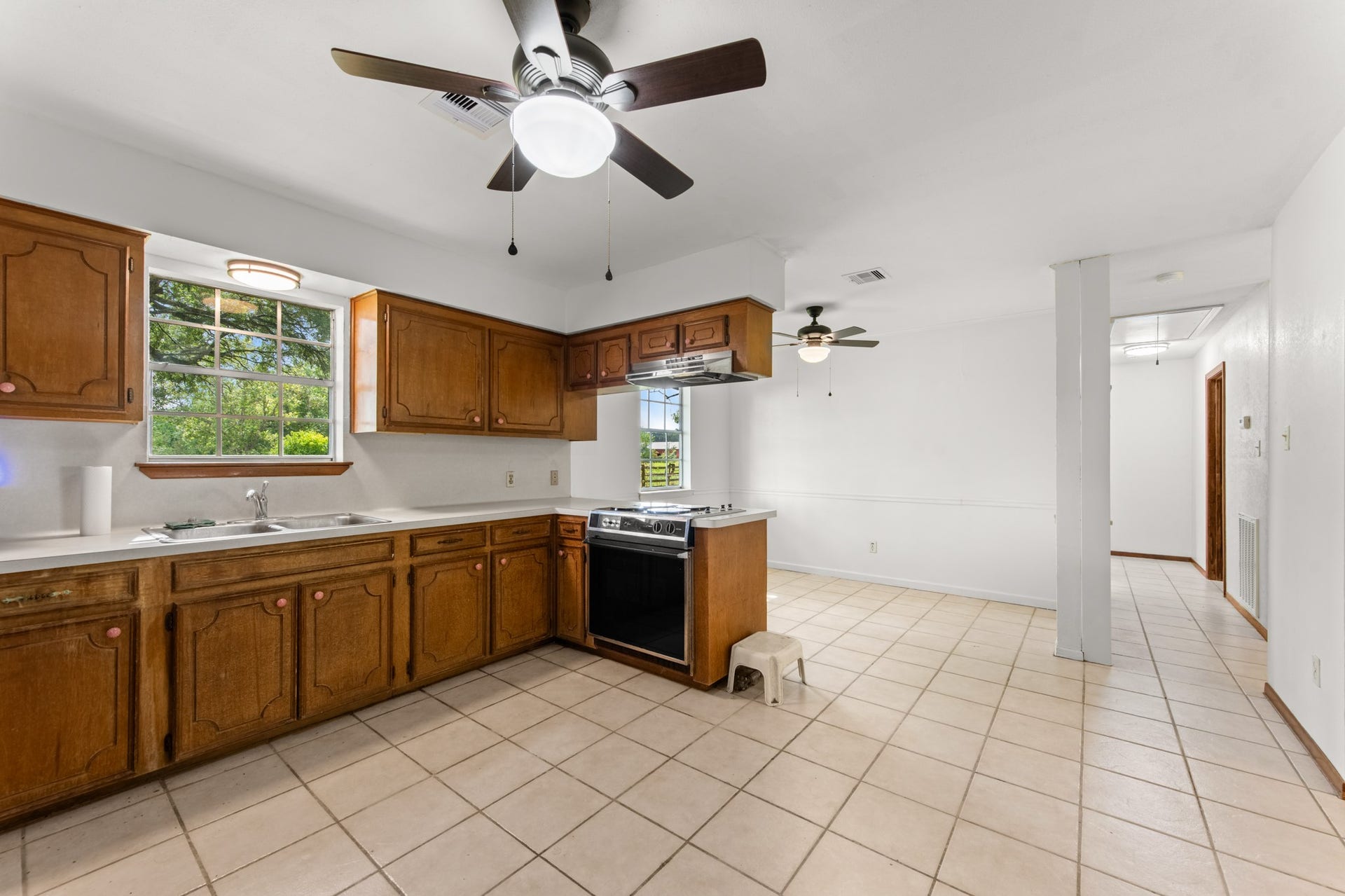 11325 32nd Street, Santa Fe, TX 77510 Natural light pours through the kitchen window above the double-basin sink, while the adjoining dining area provides an easy flow for everyday meals and entertaining.