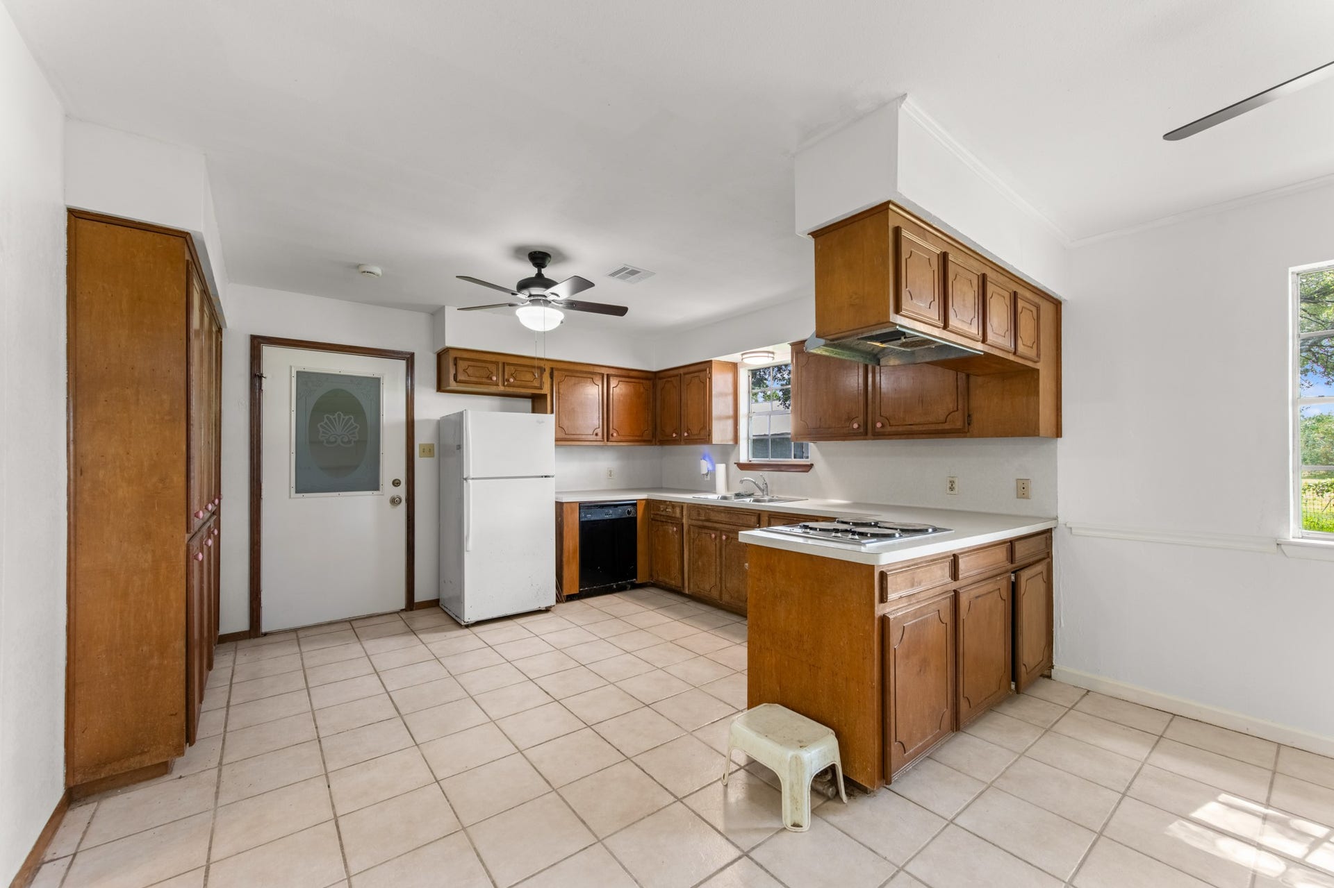 11325 32nd Street, Santa Fe, TX 77510 Spacious kitchen featuring abundant wood cabinetry, generous counter space, tile flooring, and a convenient layout with an adjoining dining area.