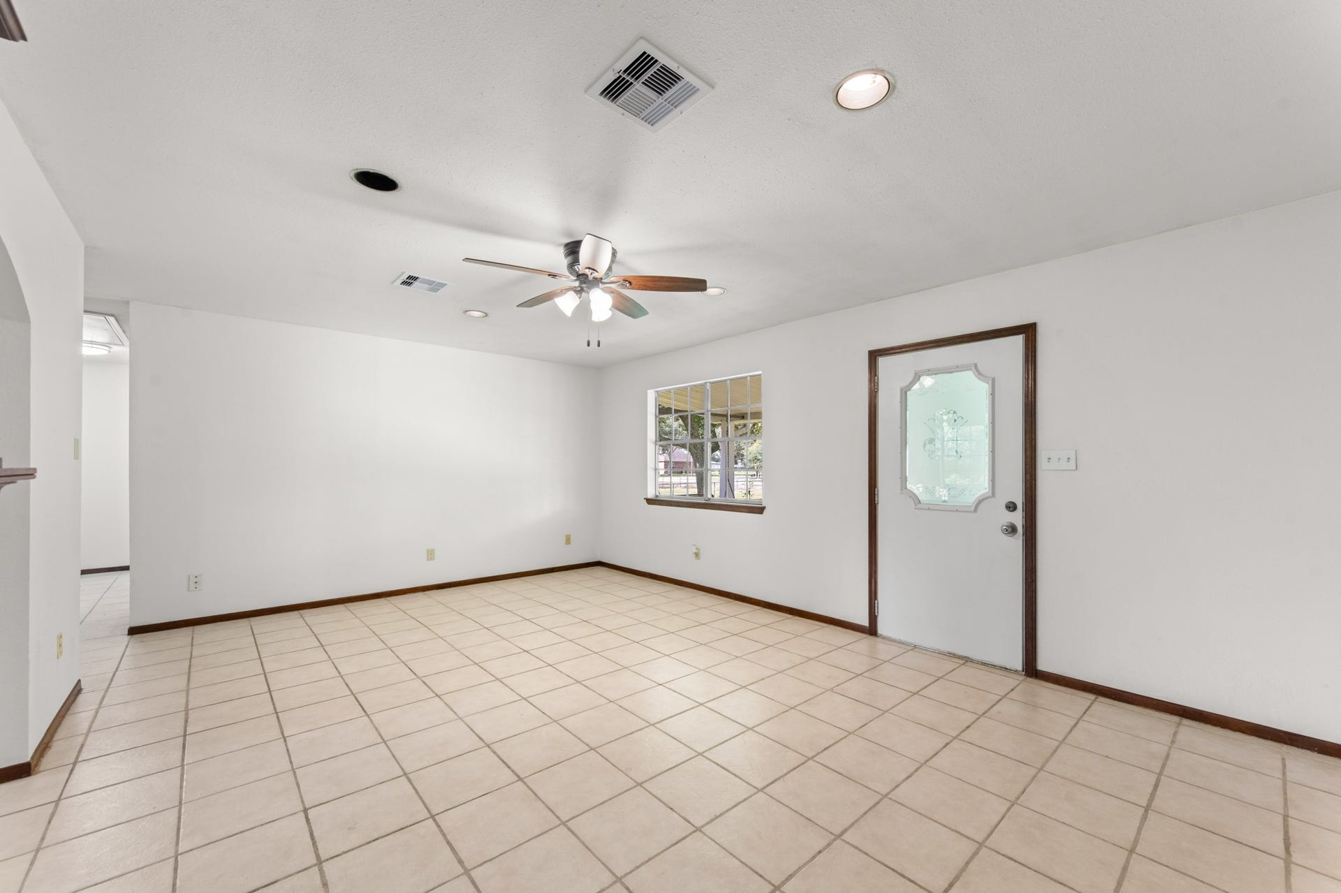 11325 32nd Street, Santa Fe, TX 77510 An inviting living area with a large front-facing window, decorative glass entry door, and plenty of room for comfortable seating and entertaining.