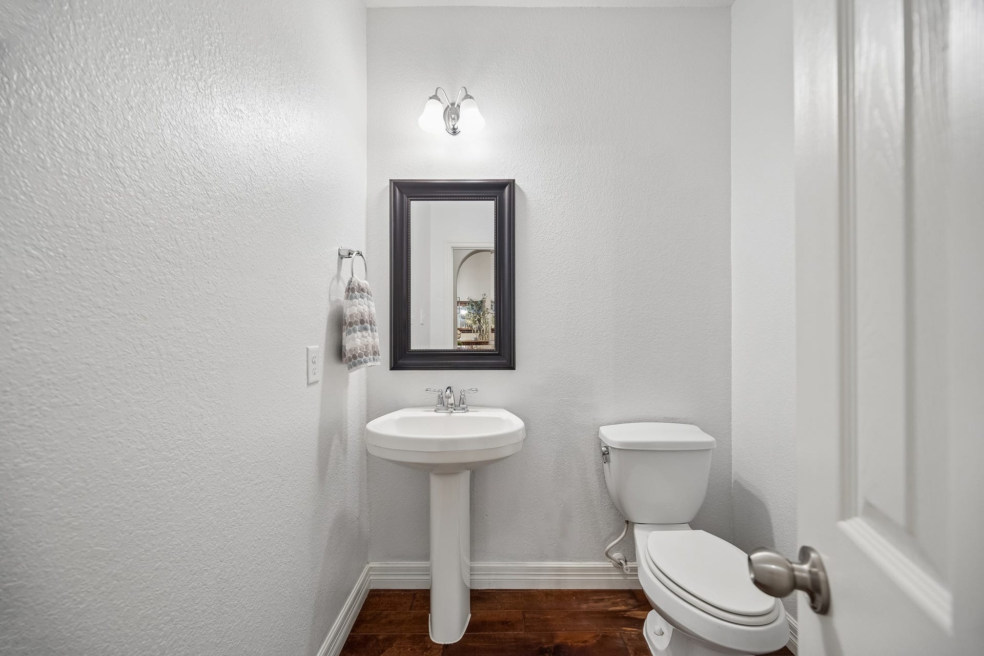 3102 London Lane, Missouri City, TX 77459 The powder room is tucked away from all the living areas.