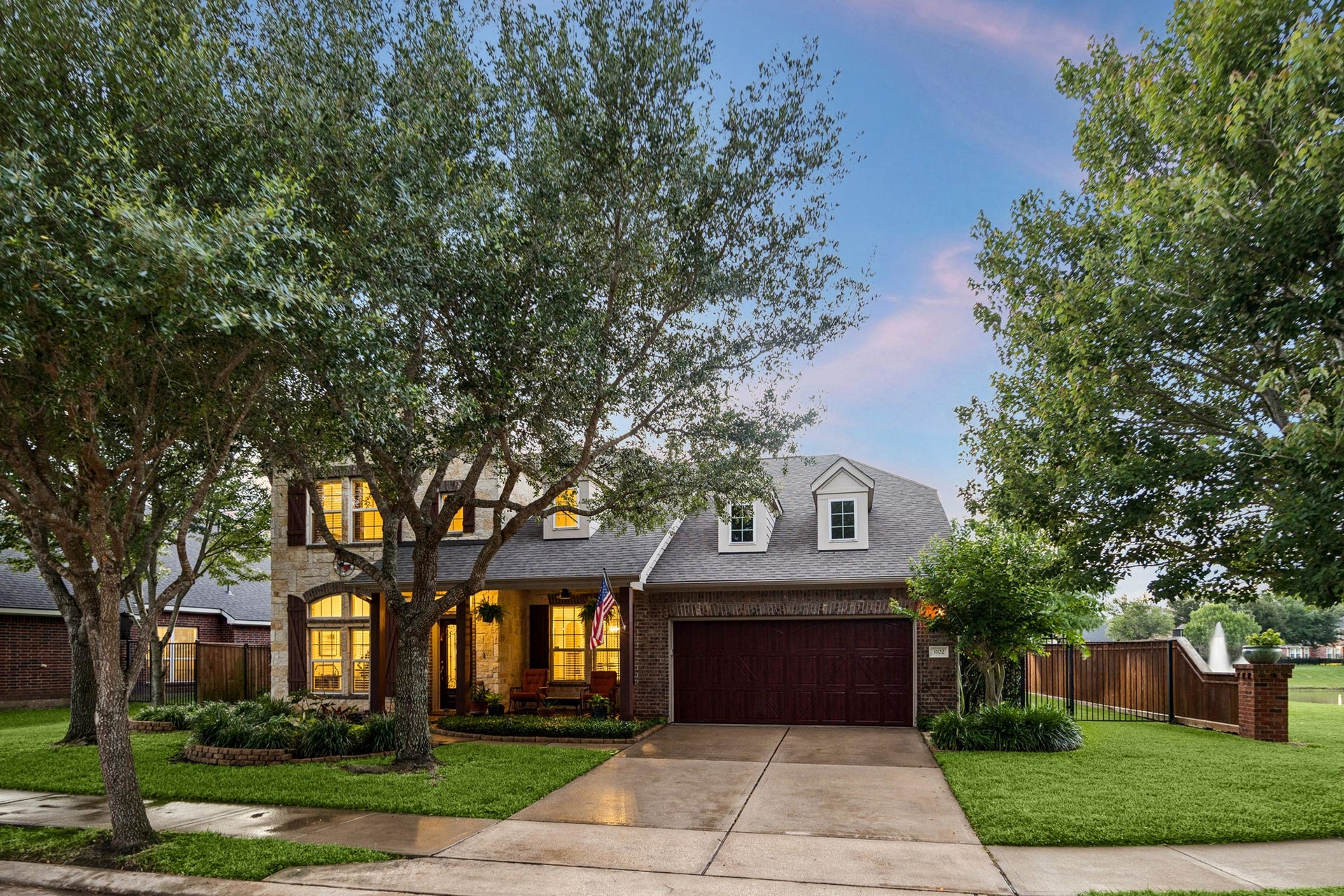 3102 London Lane, Missouri City, TX 77459 The professional landscaping sets this yard apart.