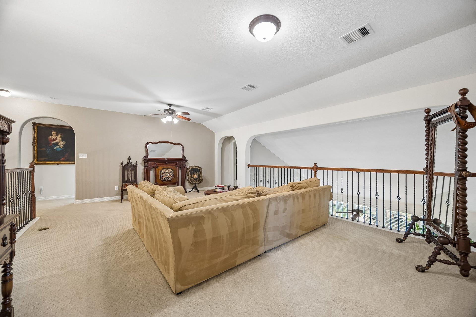 3102 London Lane, Missouri City, TX 77459 At the top of the stairs you'll find an open gameroom. The arch to the left of the wrought irong rail (opposite) leads to a media room.