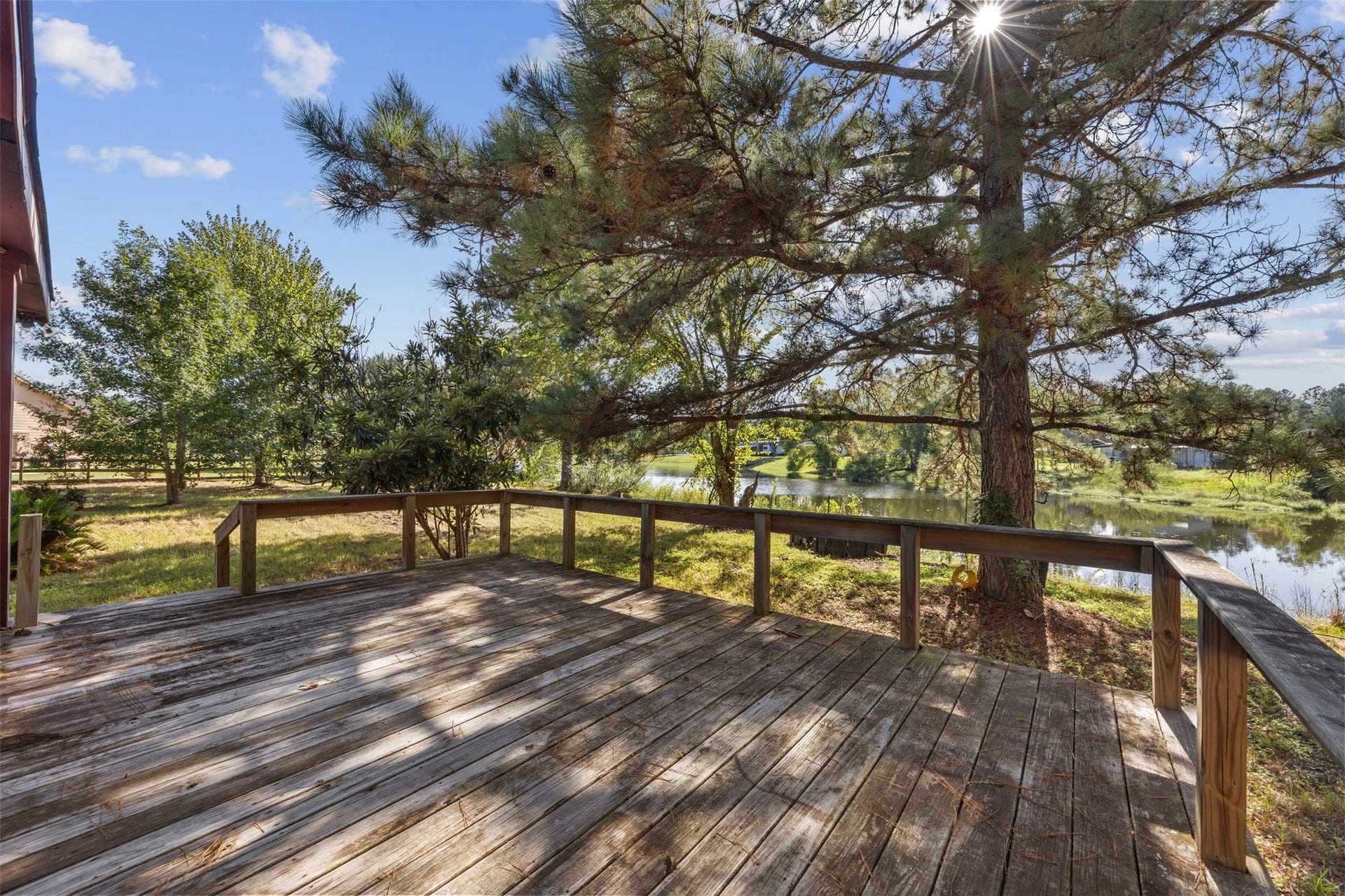 9944 Chestnut Court, Montgomery, TX 77316 Enjoy peaceful views of the shared pond from the spacious wooden deck, where mature trees provide a beautiful natural backdrop for outdoor relaxation and entertaining.
