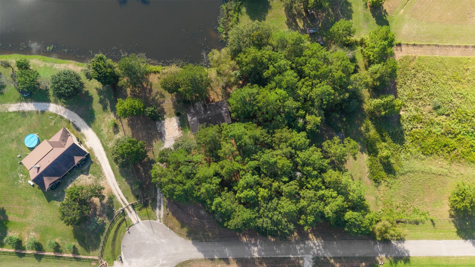 9944 Chestnut Court, Montgomery, TX 77316 An overhead view highlights the home's placement on approximately 2.8 acres in Stone Ranch, showcasing the property's wooded landscape, natural privacy, and proximity to the shared pond.