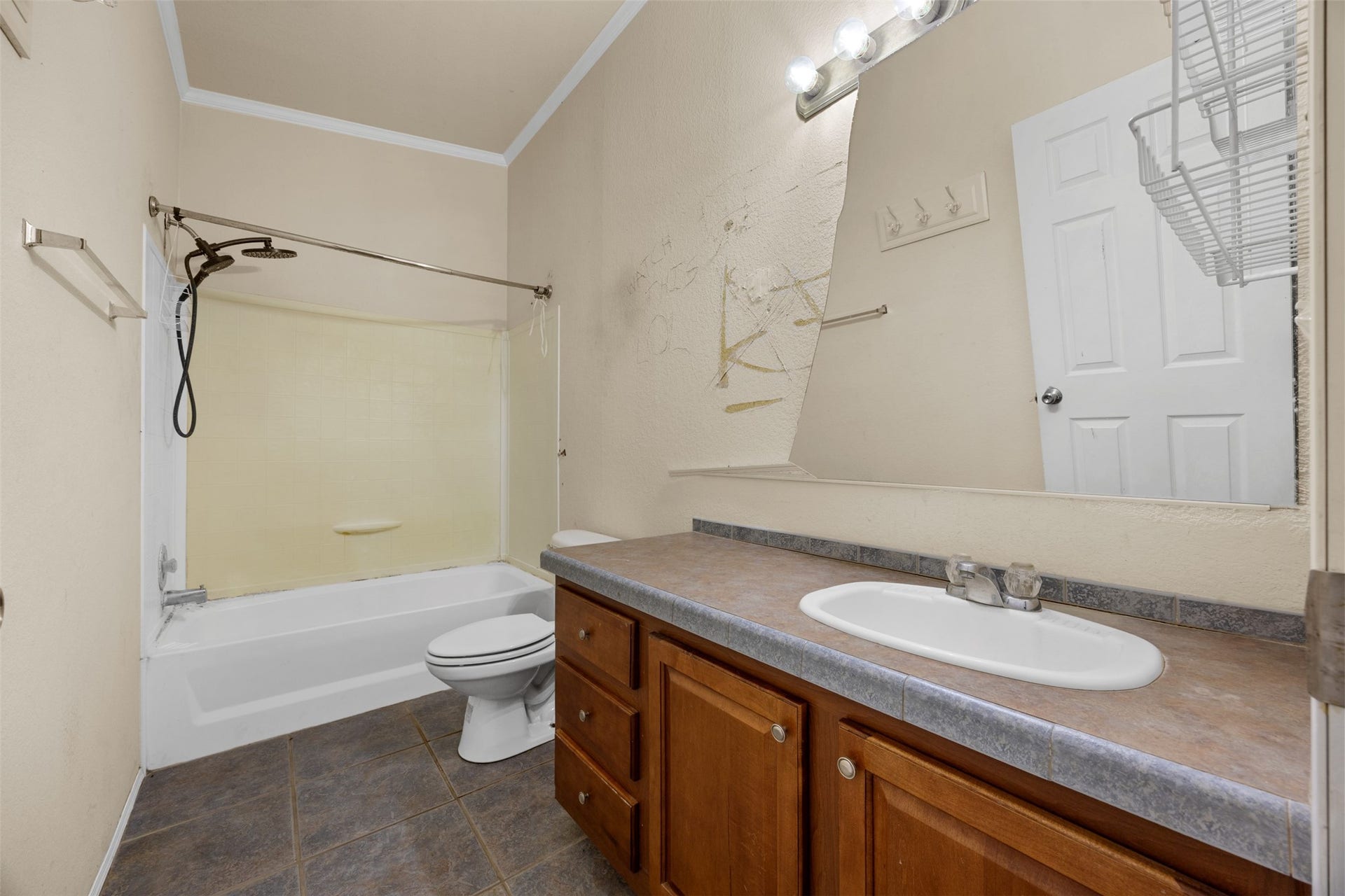 9944 Chestnut Court, Montgomery, TX 77316 The secondary bathroom features a tub and shower combination, single-sink vanity with cabinet storage, and tile flooring, offering a functional space with potential for future updates.