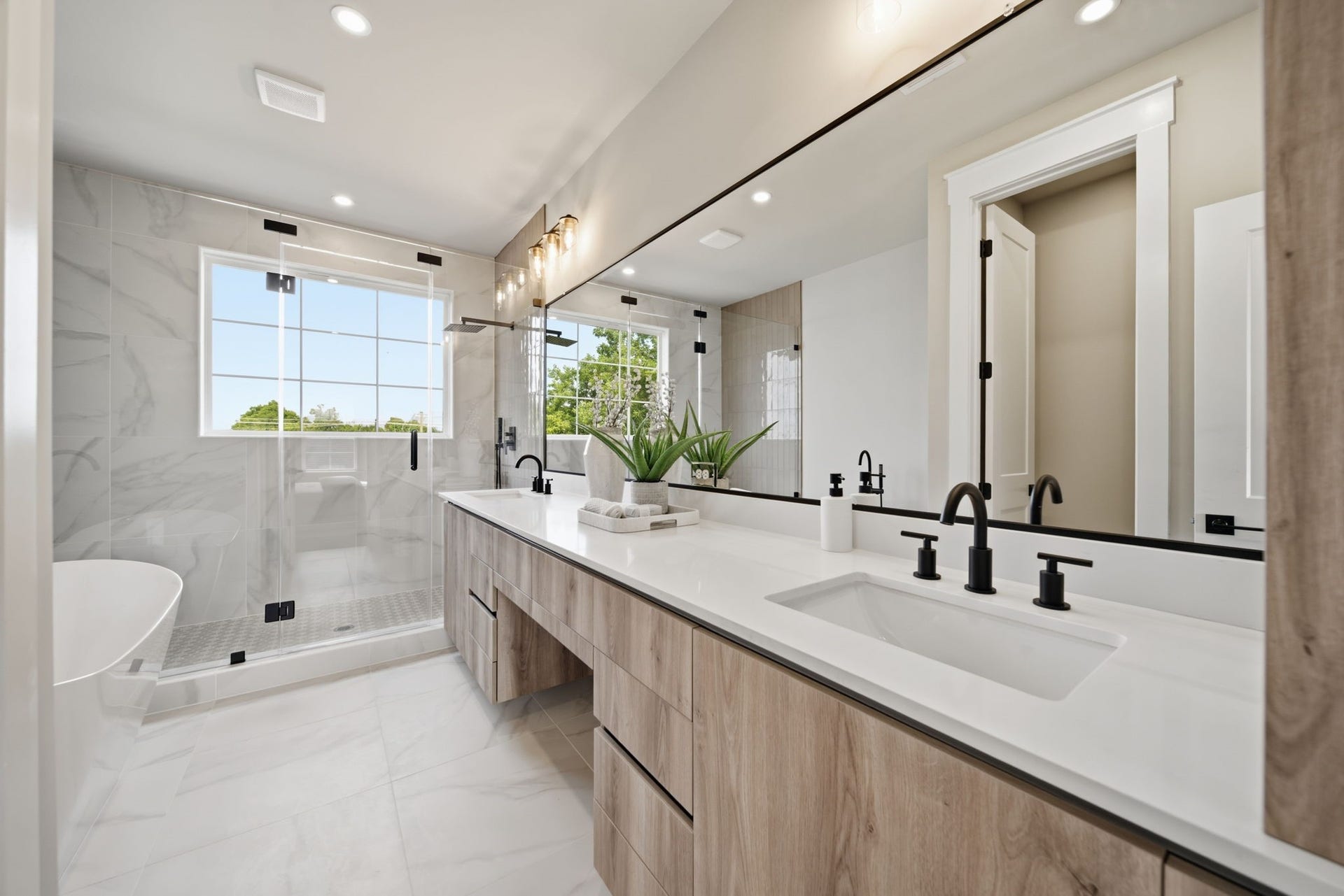 Primary bath features a oversized walk-in shower, dual sinks, vanity, and a soaking tub for a spa like feel at home.