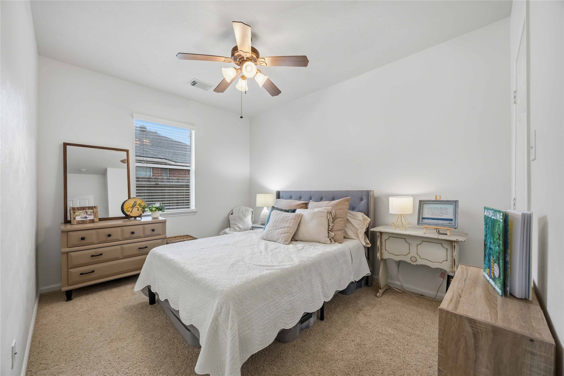 11415 English Rose Trail, Missouri City, TX 77459 Bright secondary bedroom featuring neutral carpeting, a ceiling fan, and a window providing natural light.