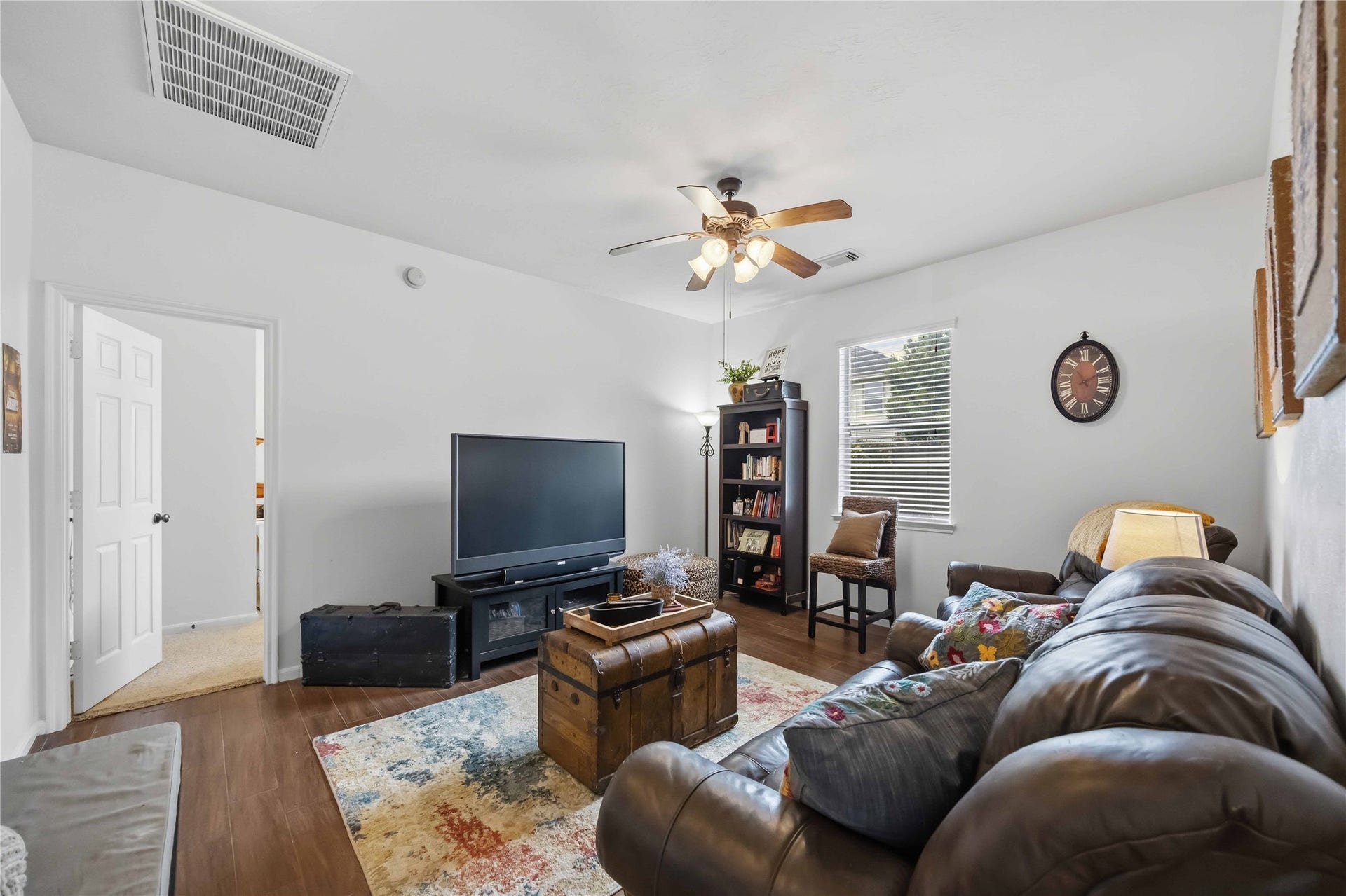 11415 English Rose Trail, Missouri City, TX 77459 Versatile den with wood-look tile flooring, ceiling fan, and natural light, ideal for a home office or media room.