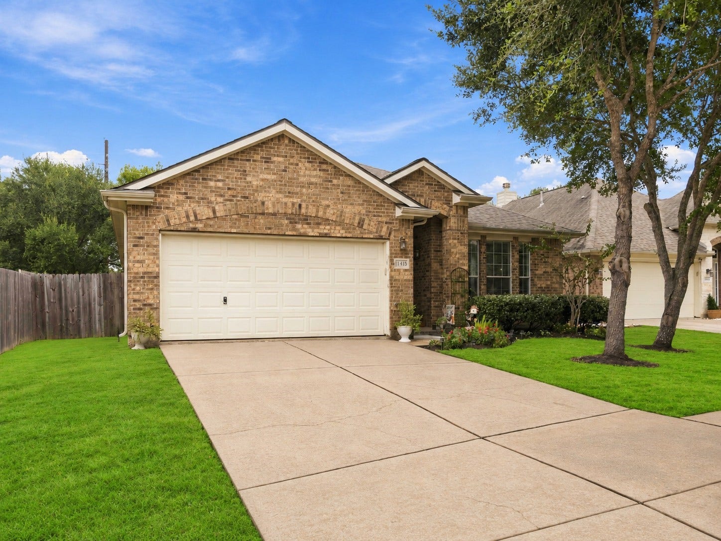 11415 English Rose Trail, Missouri City, TX 77459 Charming single-story brick home with a two-car garage, mature trees, and a spacious front lawn.