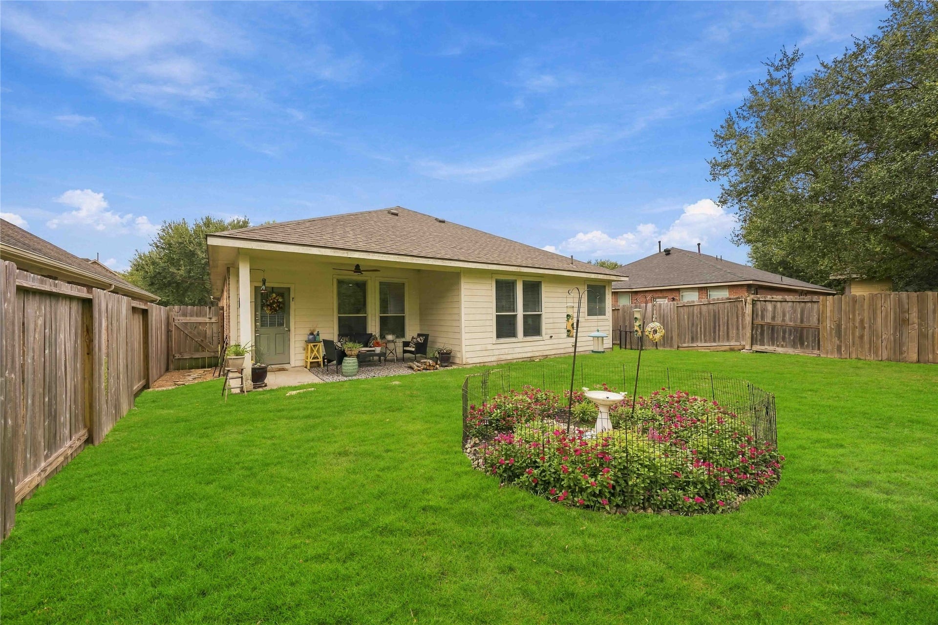 11415 English Rose Trail, Missouri City, TX 77459 Rear exterior showcases the covered patio, multiple windows, and ample outdoor space for recreation.