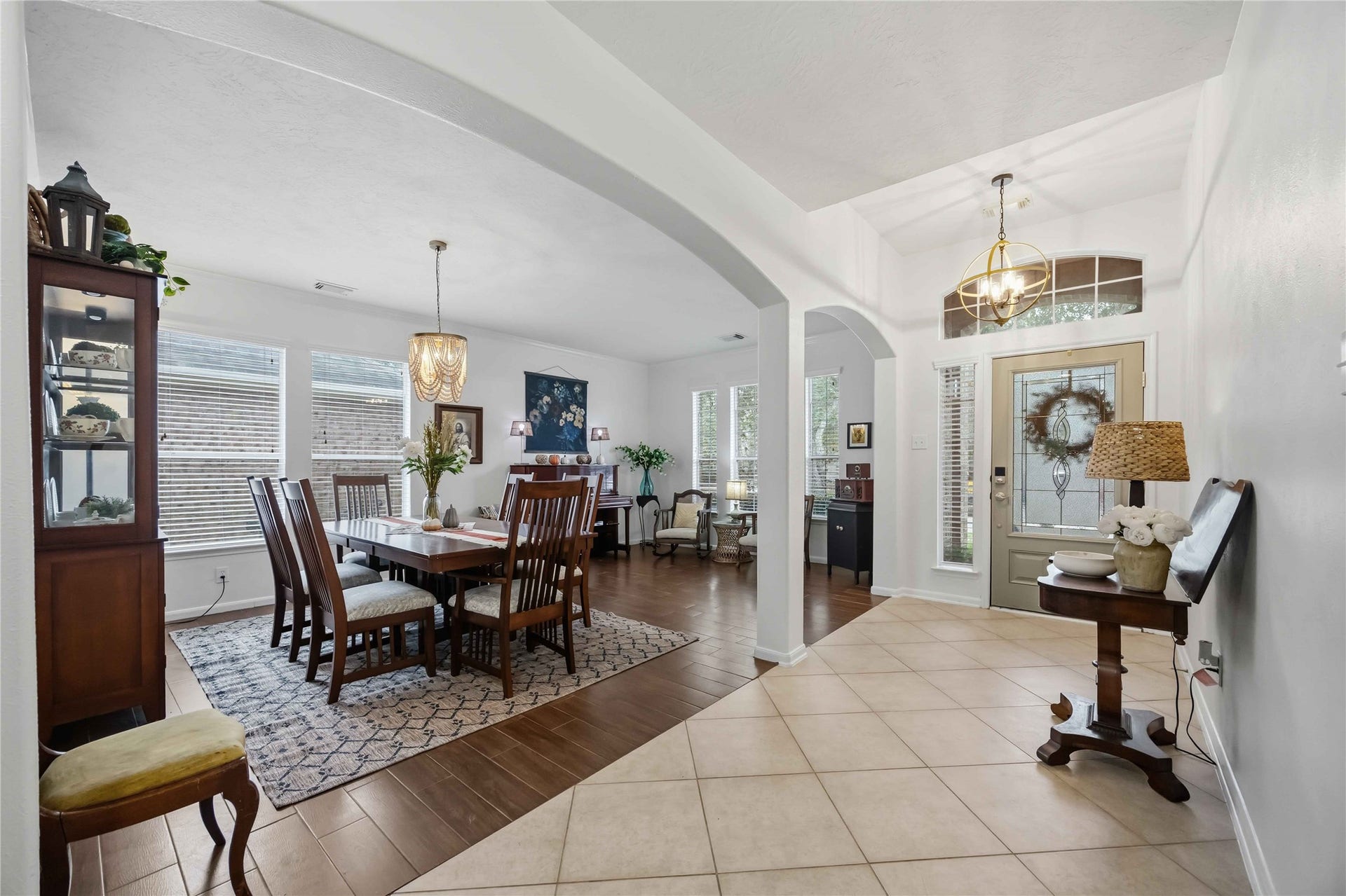 11415 English Rose Trail, Missouri City, TX 77459 Open view of the foyer and dining area showcasing architectural arches, high ceilings, and a seamless layout for entertaining.