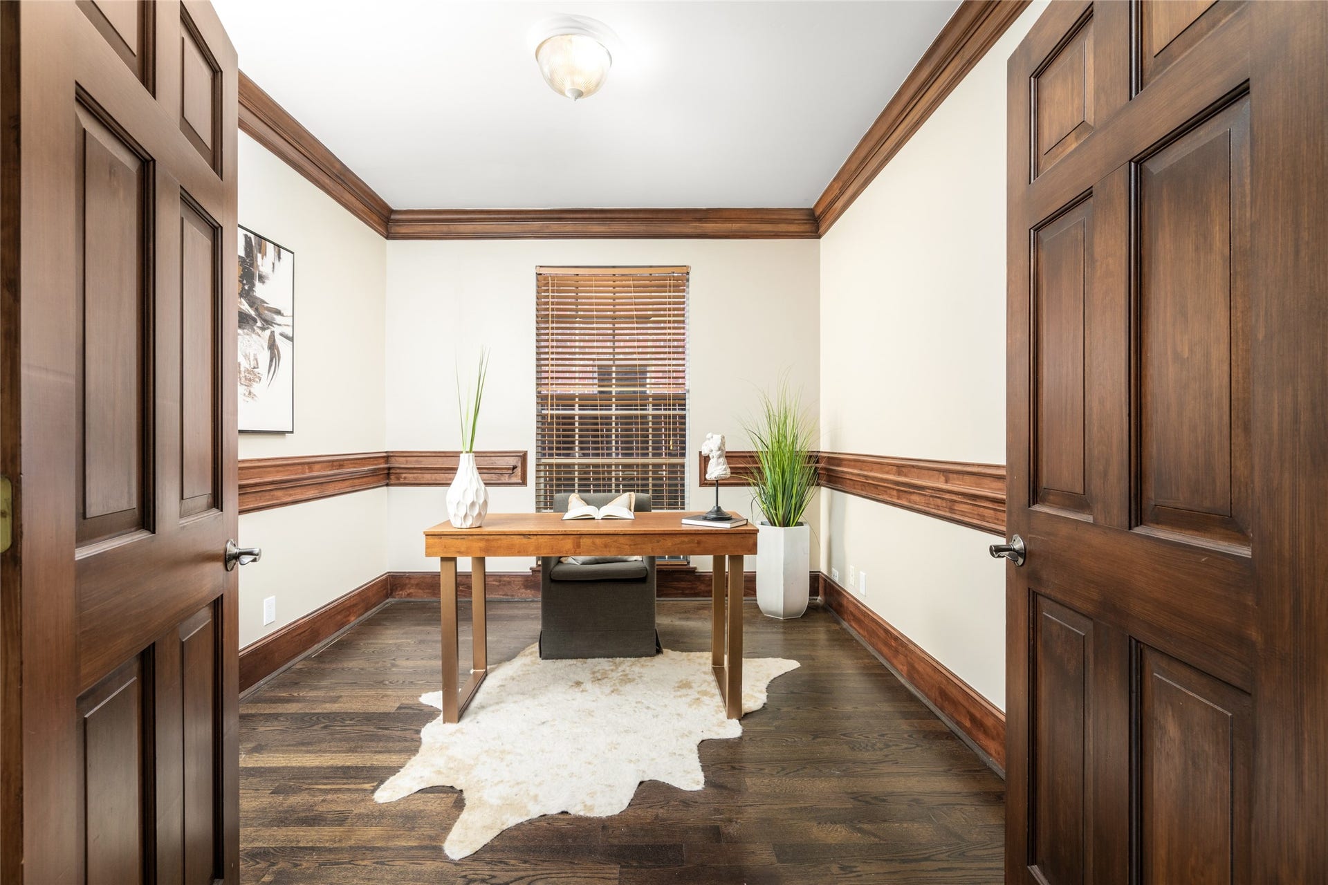 4312 Holt Street, Bellaire, TX 77401 Behind stately double doors, the private study exudes warmth and sophistication. Rich stained wood crown molding, chair rail, and base trim lend timeless, custom-built character. An ideal retreat for working from home, a library, or a quiet reading room.