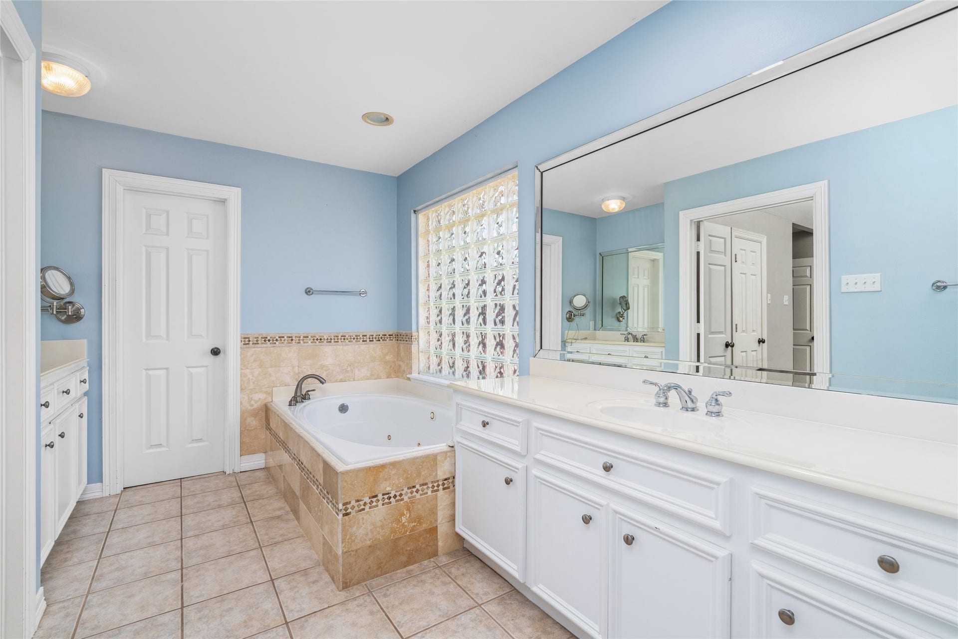 4312 Holt Street, Bellaire, TX 77401 Soft blue walls set a calm tone in this bright bath.