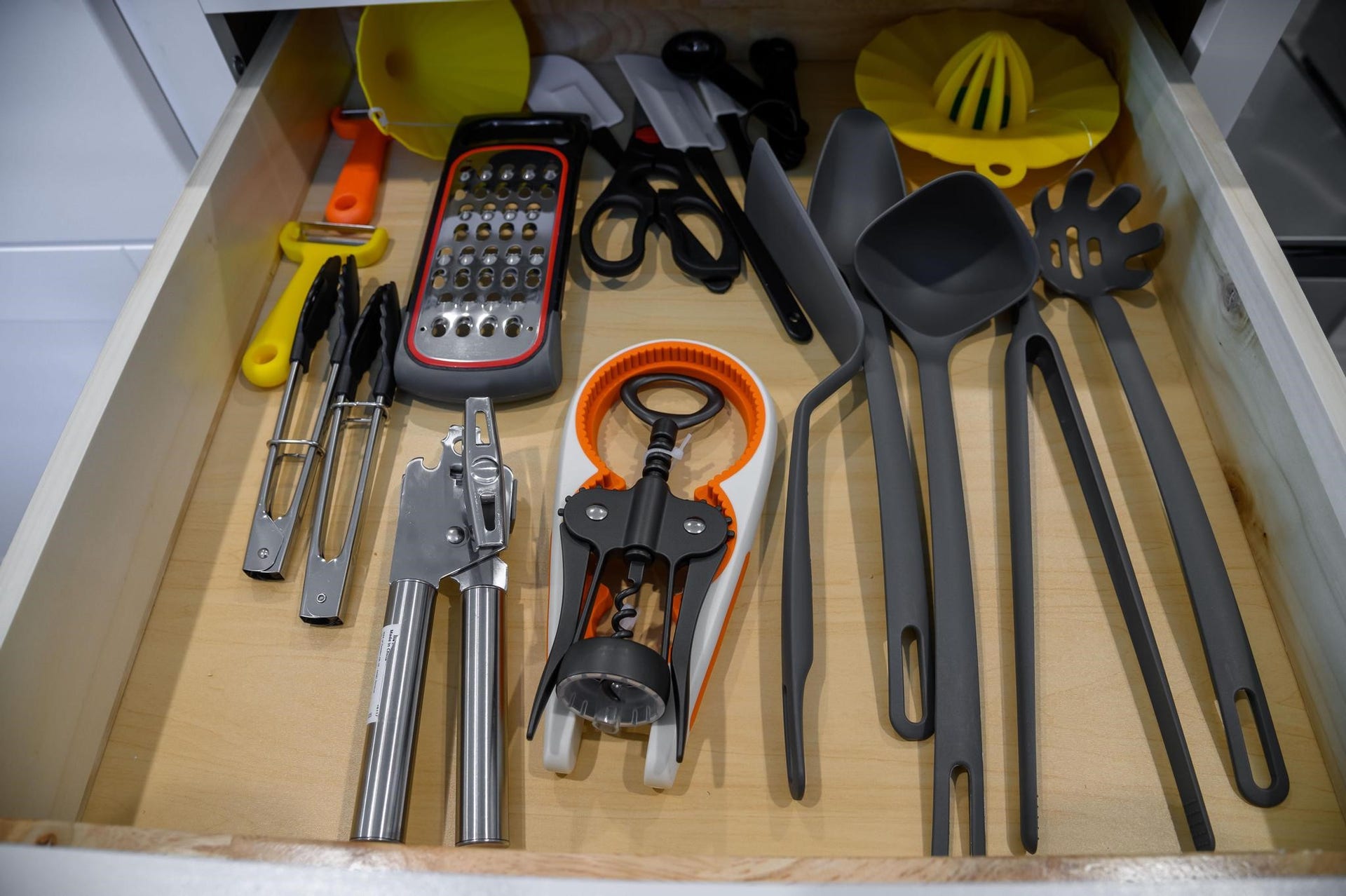 A well-organized kitchen drawer featuring essential utensils and gadgets ensures easy access and efficiency for all your culinary needs.