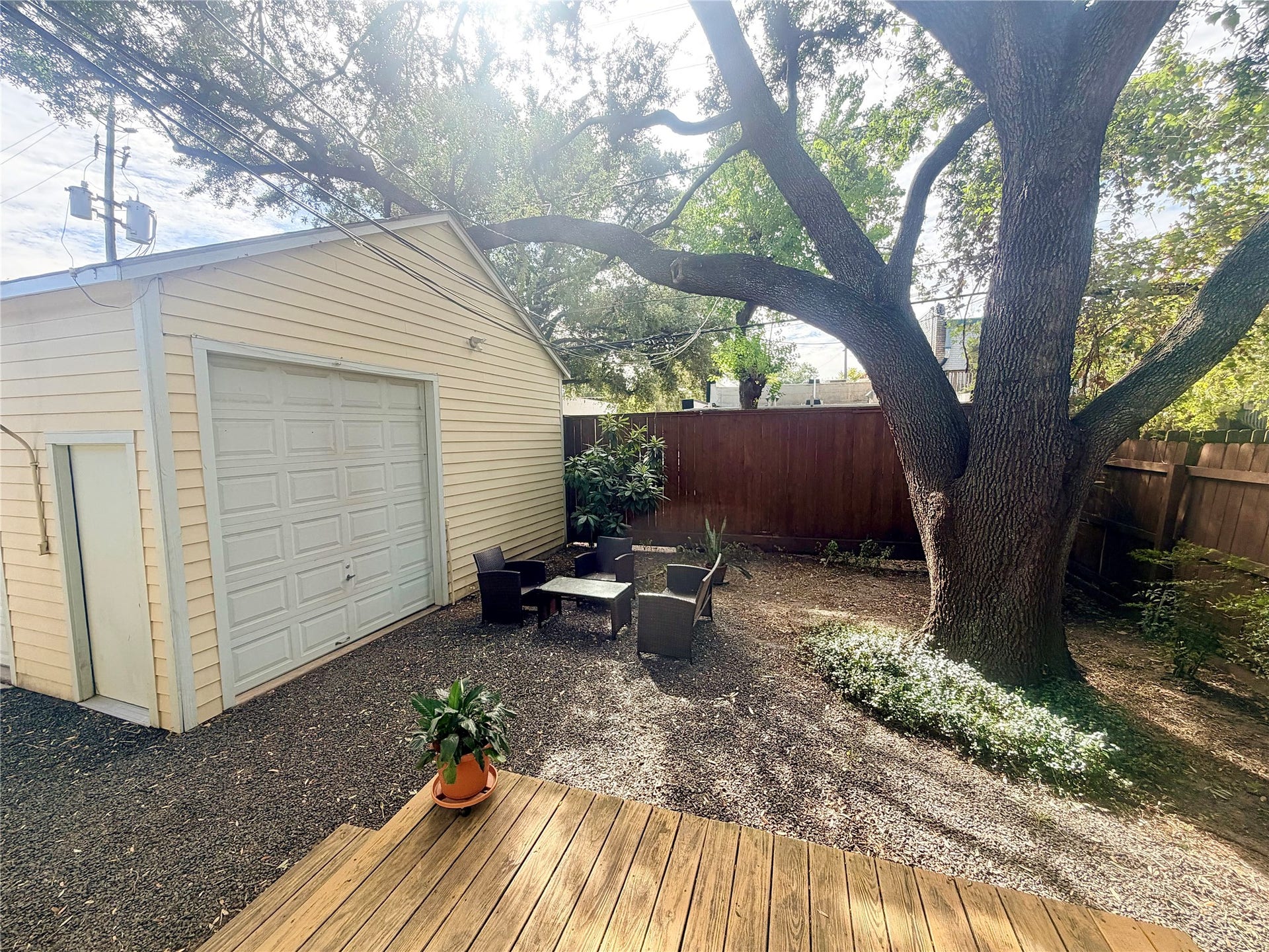 quaint open patio area with shady tree