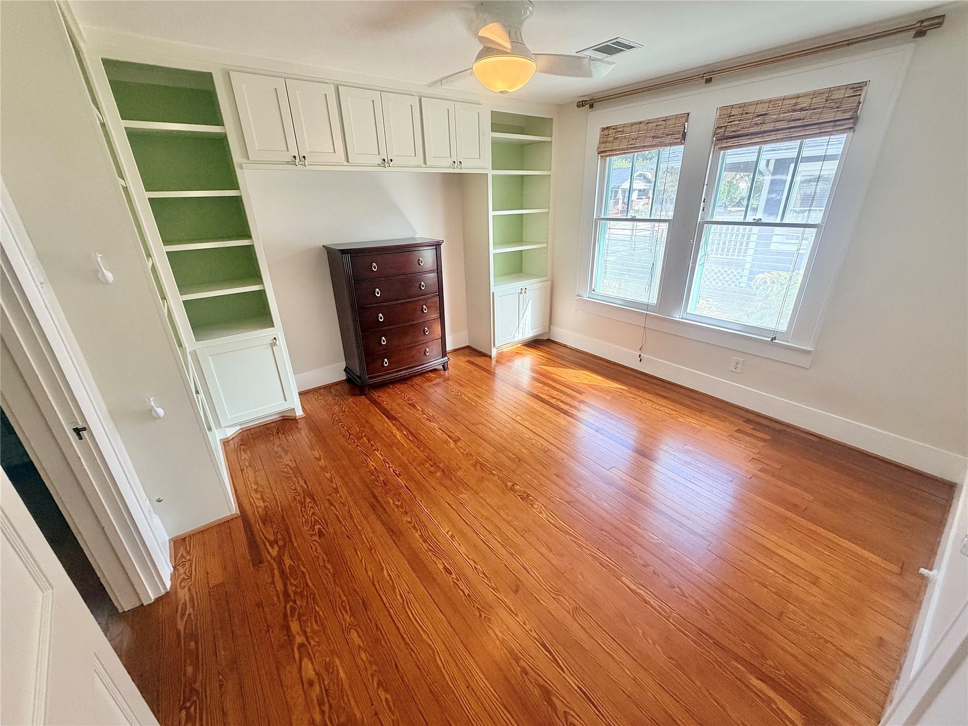 3rd bedroom space toward feont of a home with built ins also ideal home office space