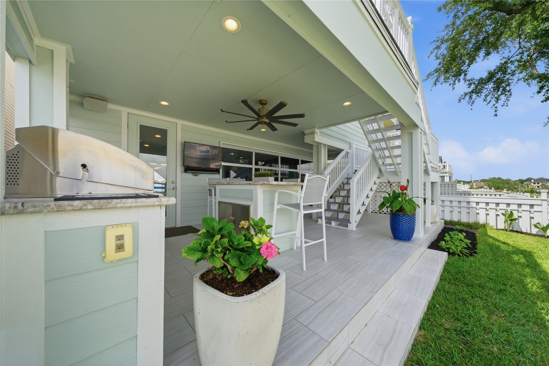 2174 Marina Way, Kemah, TX 77565 The patio off of the garage with the outdoor kitchen and stairs that go up to the 2nd floor balcony, with easy access to the kitchen.