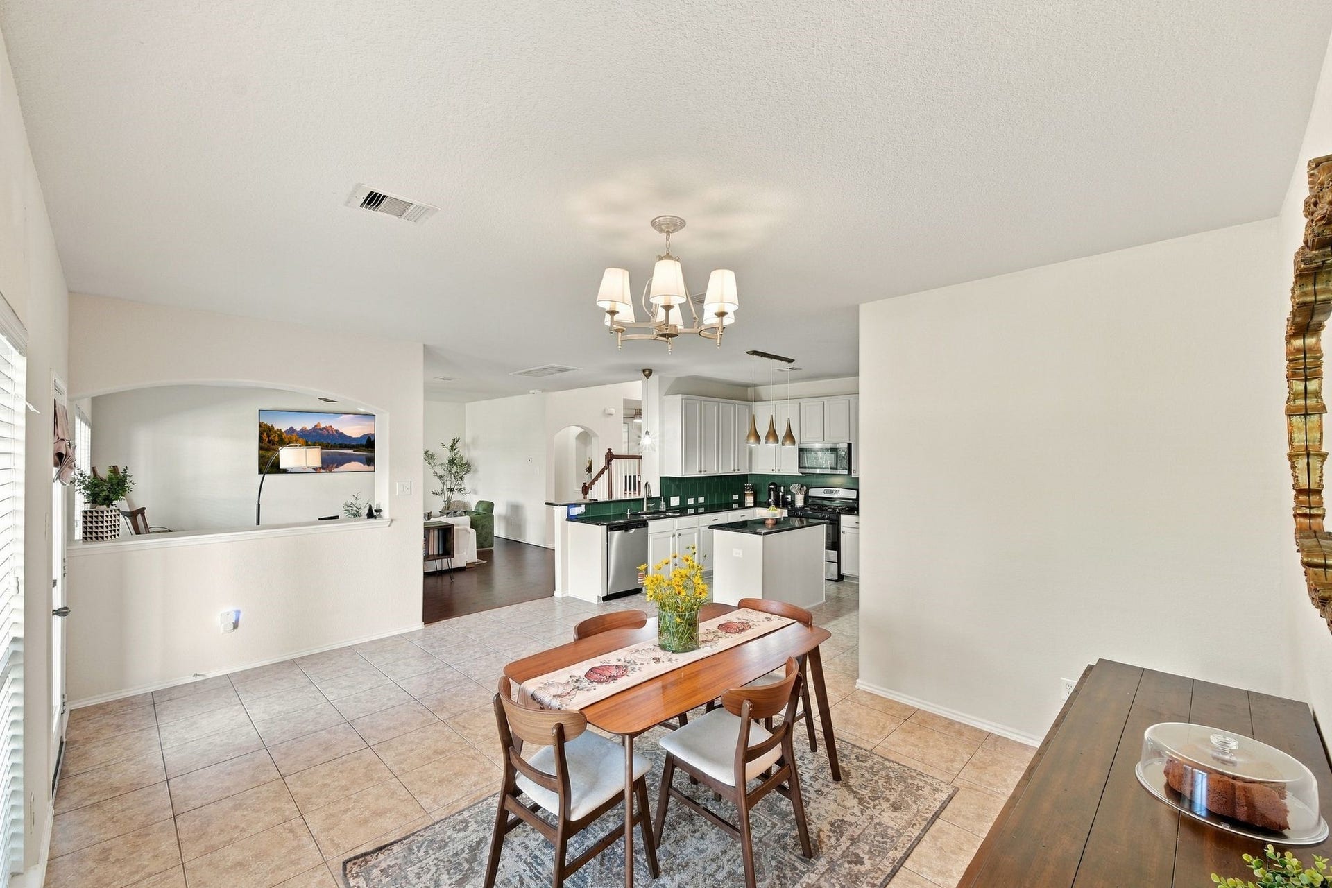 26037 Kings Mill Crest Drive, Kingwood, TX 77339 Bright and spacious open-concept living area featuring a modern kitchen with sleek countertops, a cozy dining space, and abundant natural light.