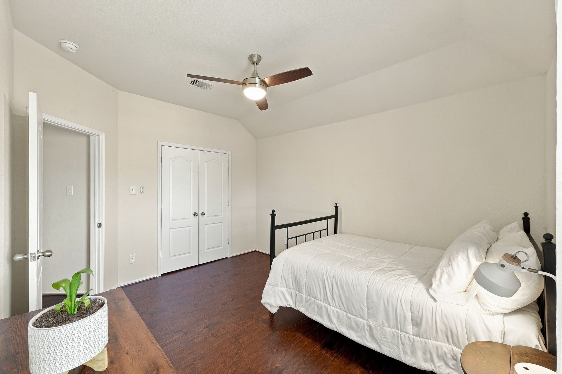 26037 Kings Mill Crest Drive, Kingwood, TX 77339 Cozy bedroom with sleek hardwood floors, a ceiling fan, and ample closet space, perfect for relaxation.