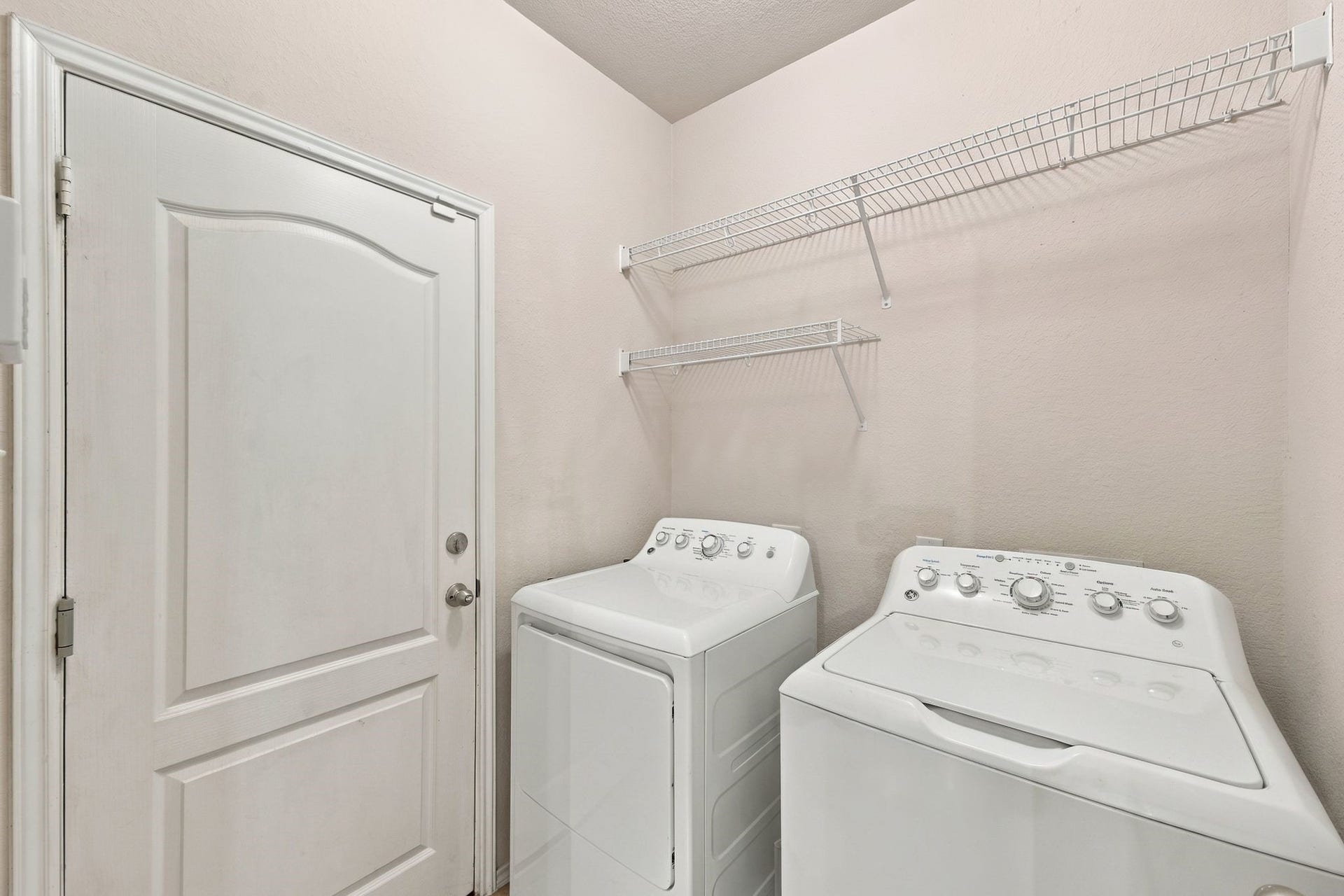 26037 Kings Mill Crest Drive, Kingwood, TX 77339 Convenient laundry room equipped with ample shelving for storage.