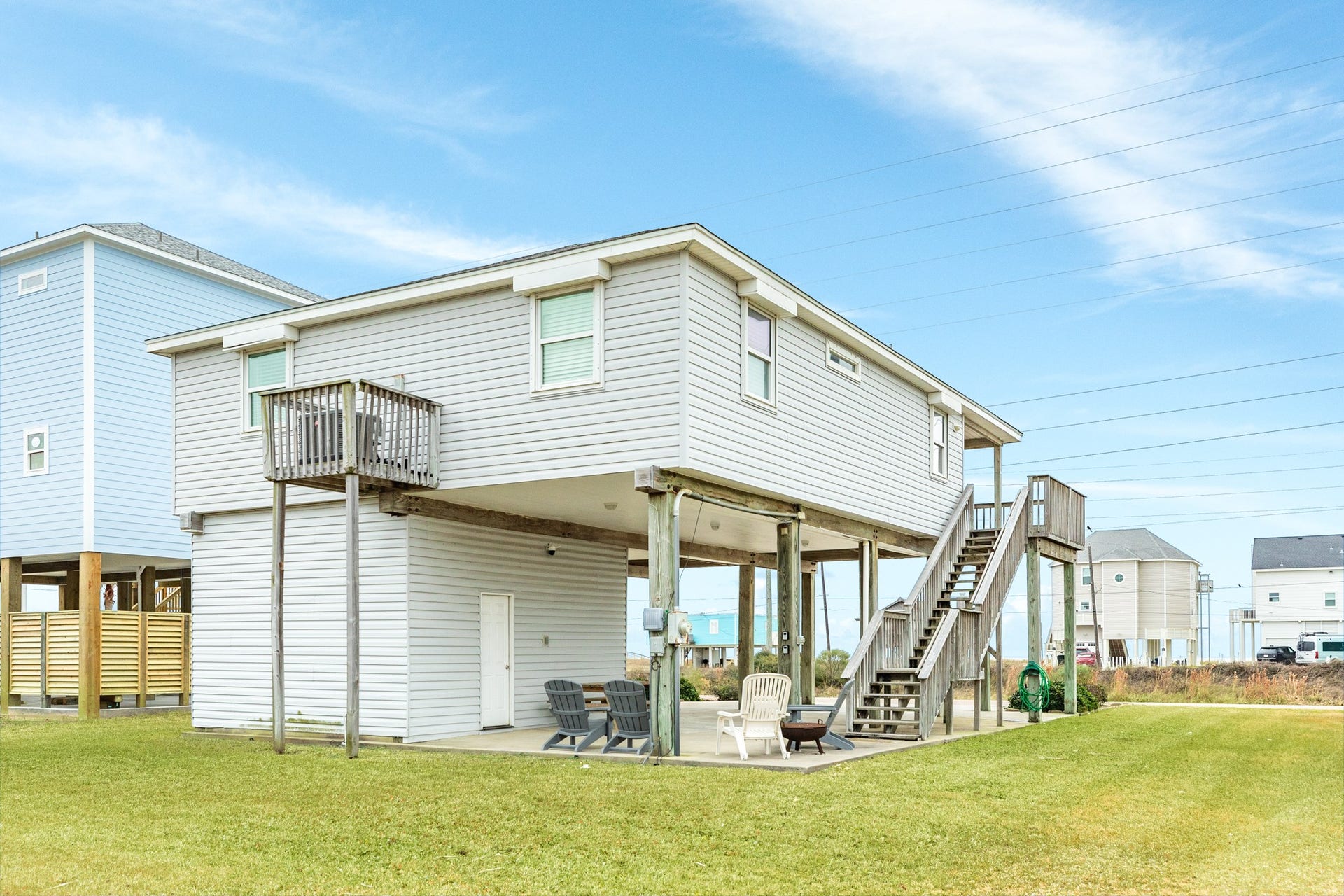 23012 Verano Drive, Galveston, TX 77554 Rear view o home, all windows have roll down shutters.