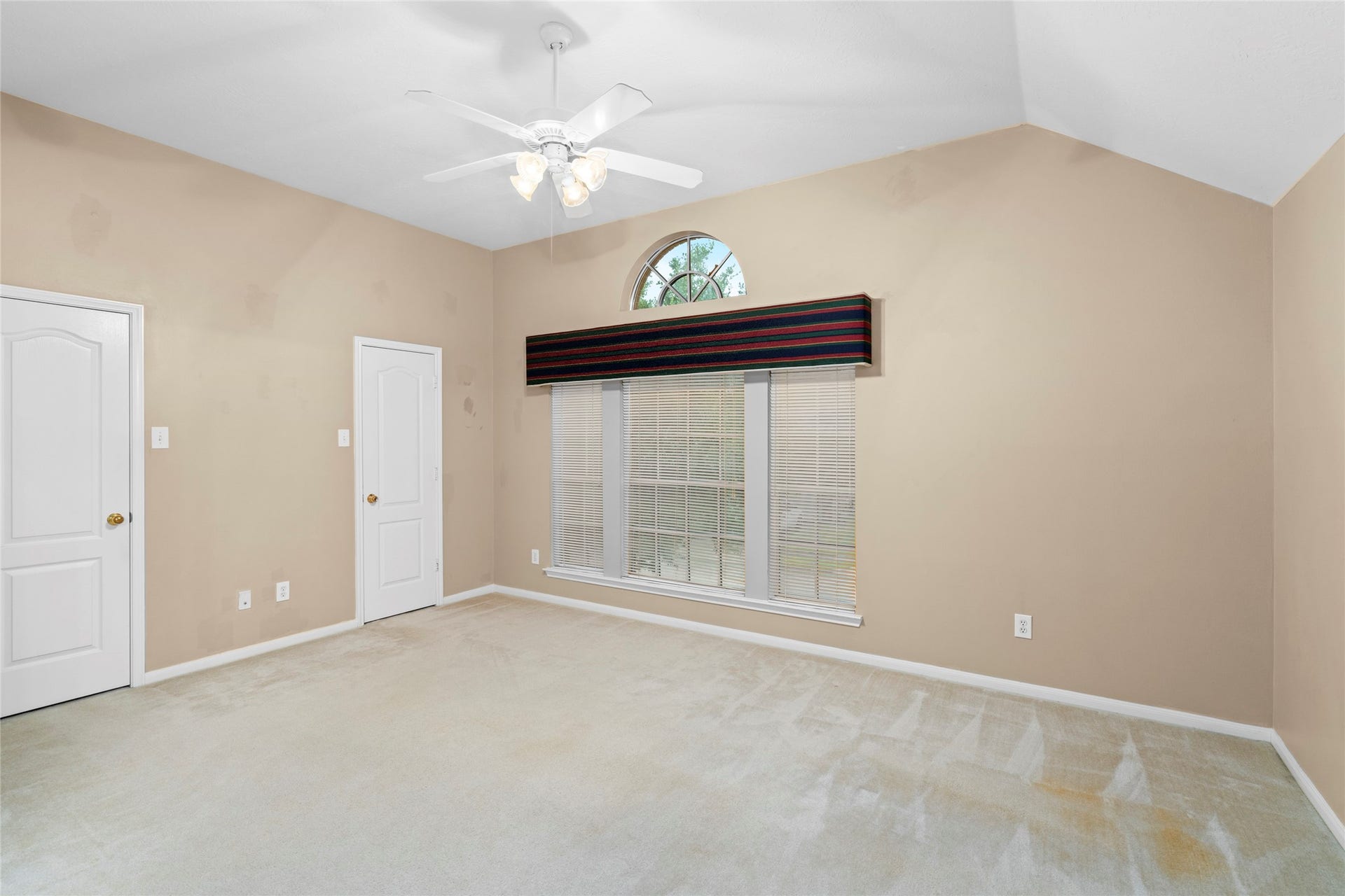 Bright upstairs space with a high ceiling and prominent arched window, offering an excellent blank canvas for personalization. Its flexible character allows a buyer to envision an office, sitting area, play space, or other purpose that fits their lifestyle.